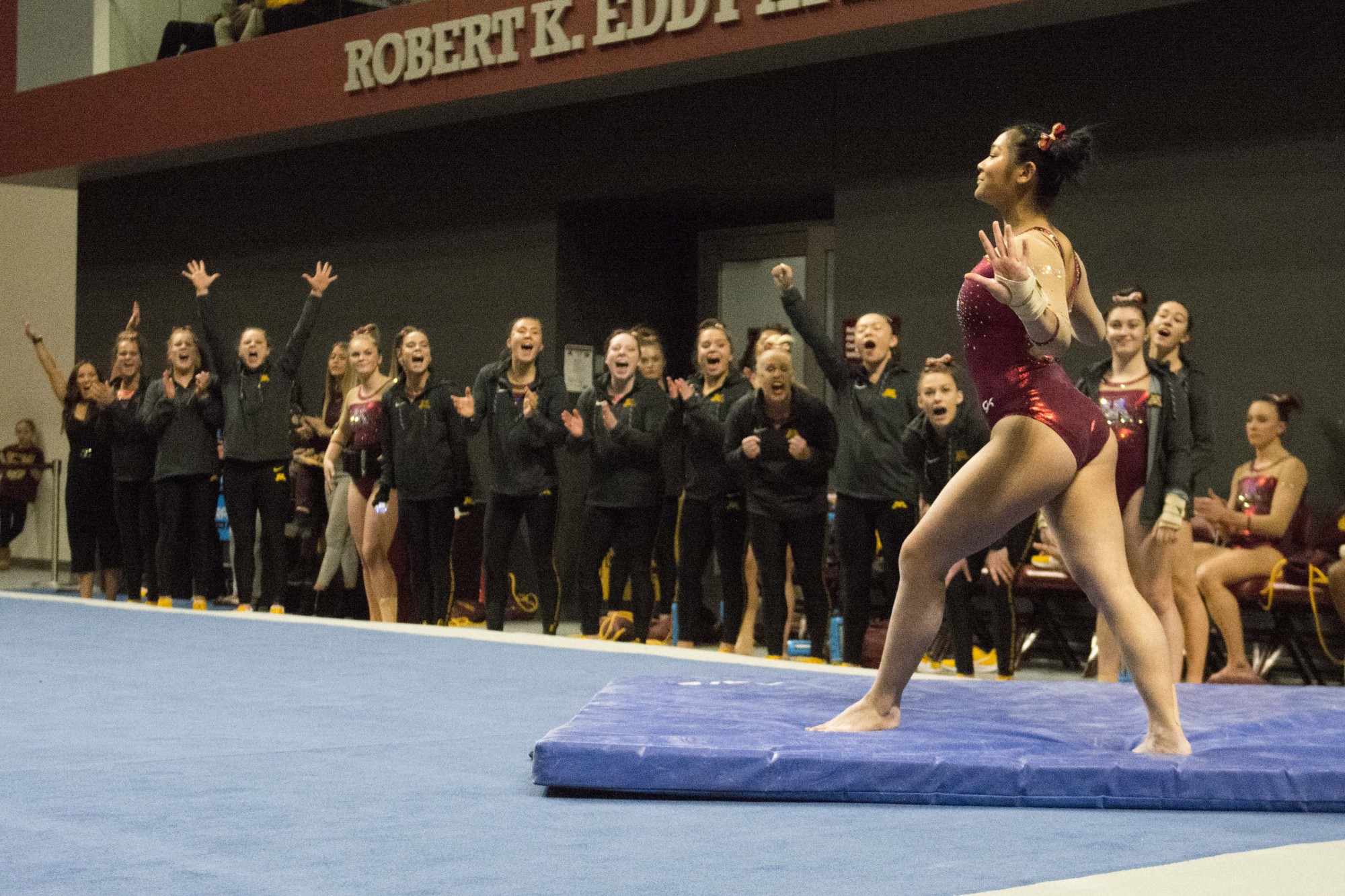 Tiarre Sales finishes her move as her teammates cheer on the side at the Maturi Pavillon on Saturday, Feb. 8. The win was the Gophers fourth in a row. 