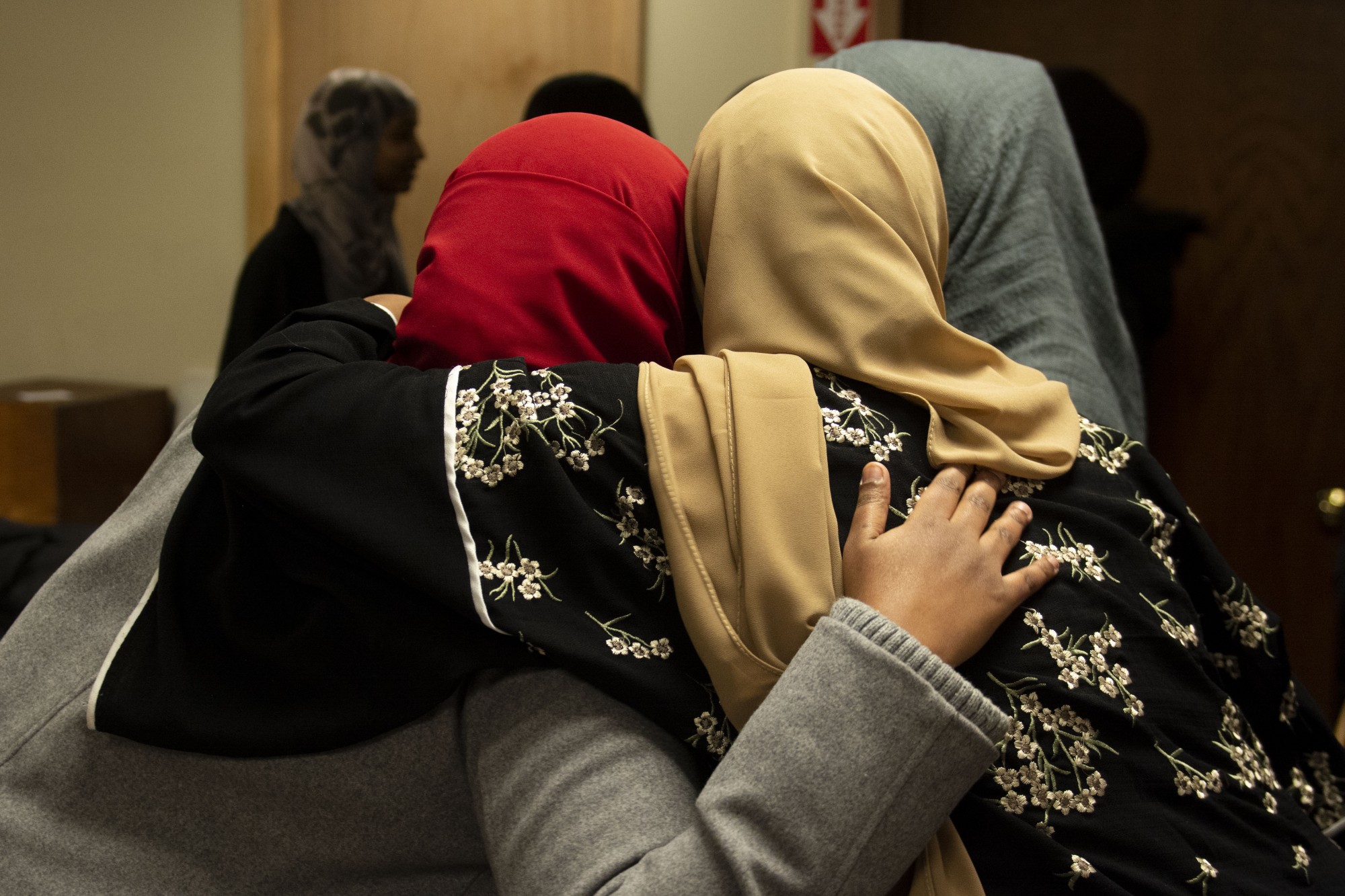 Attendees greet each other with a hug at the Muslim Alumni Network kickoff event at Masjid Al-Iman on Friday, Feb. 7.