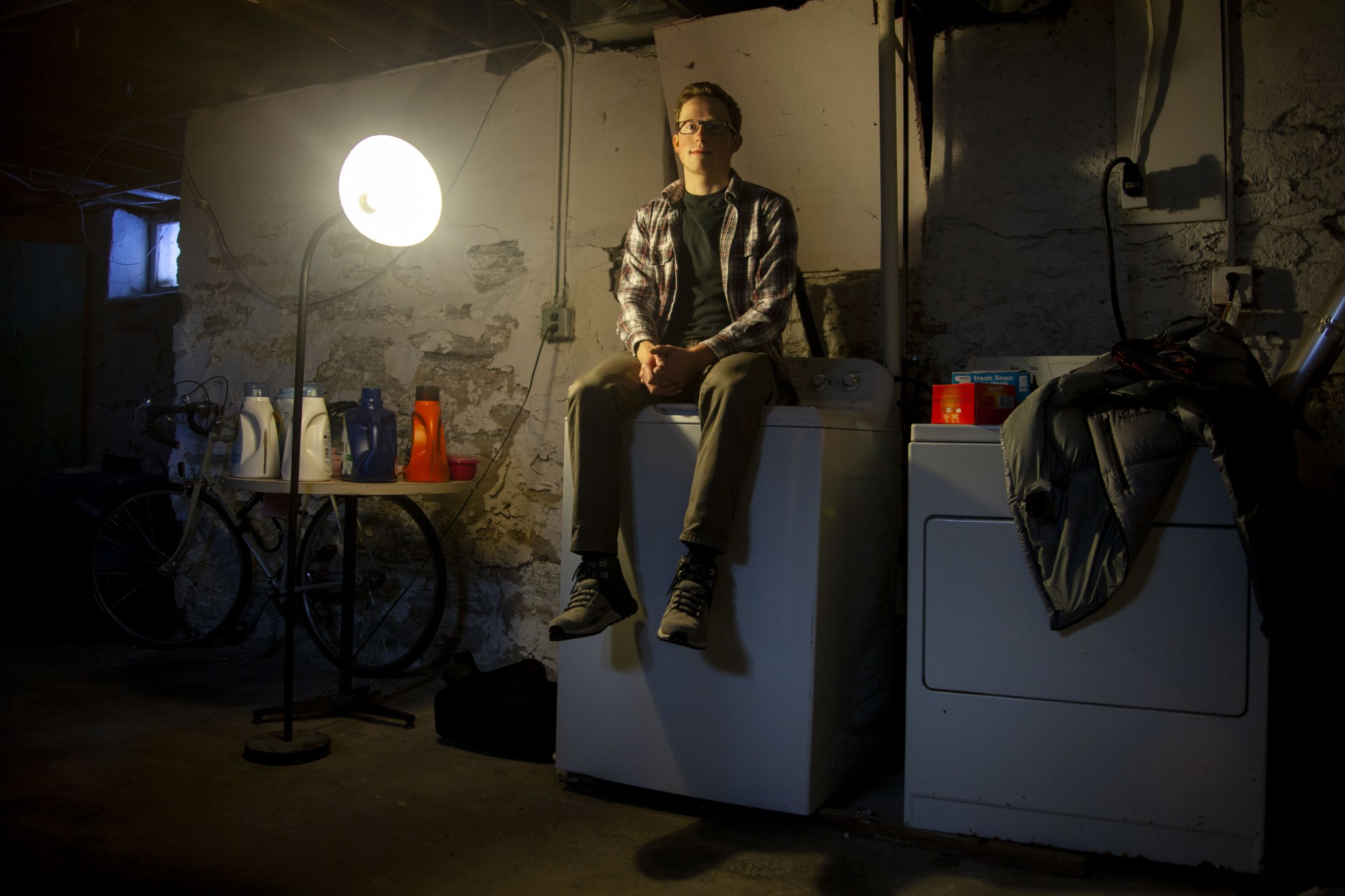 Senior Garrett Williams poses for a portrait in the basement of his former residence in the Marcy Holmes neighborhood on Saturday, Feb. 8.  The Miles Group owned property suffered from hazardous heating equipment, a partially collapsed ceiling and an overall lack of maintenance. 