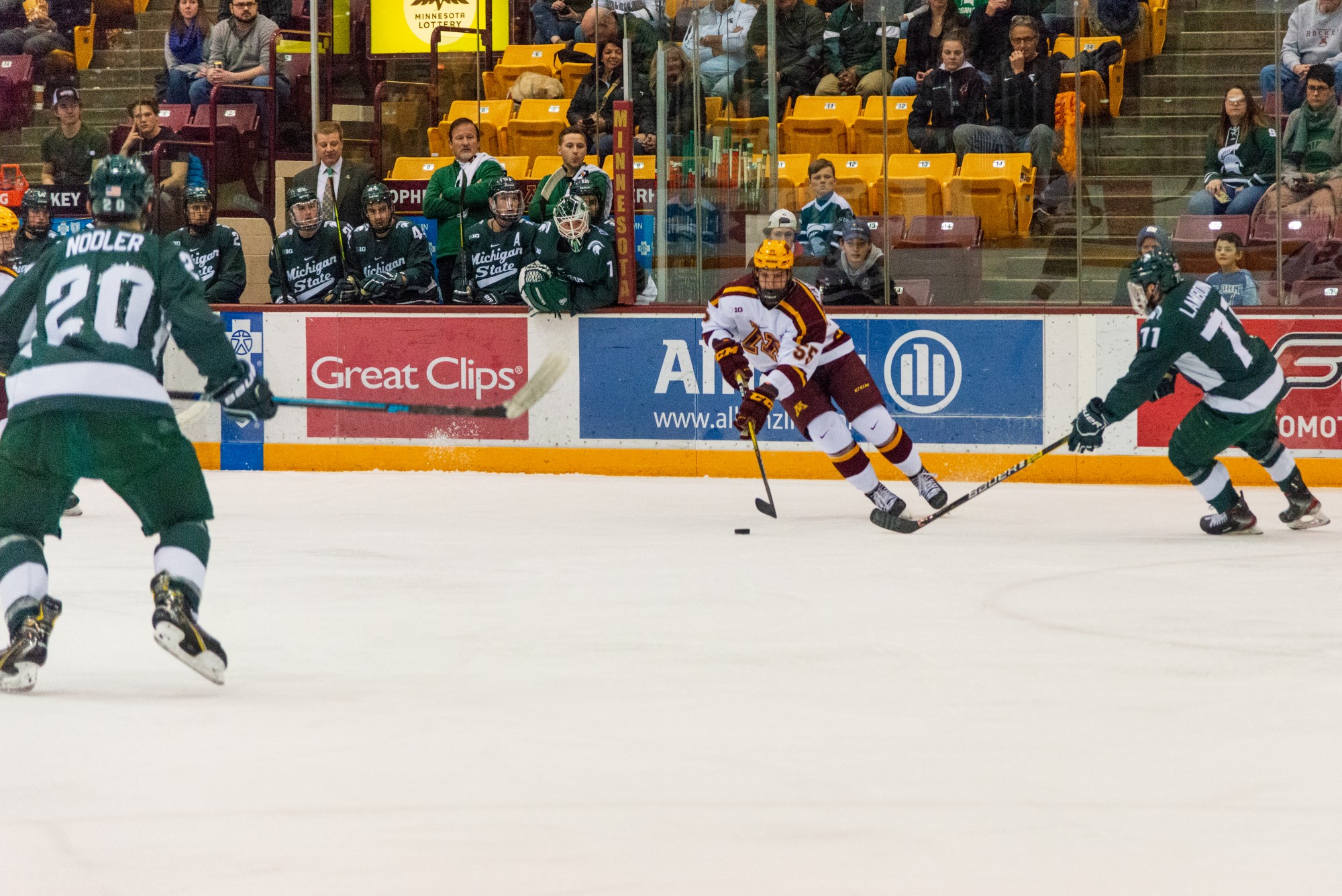 Gophers Defenseman Matt Staudacher dodges a defender at the 3M Arena at Marriucci on Friday, Feb. 7. Gophers won against Michigan State 4-1.