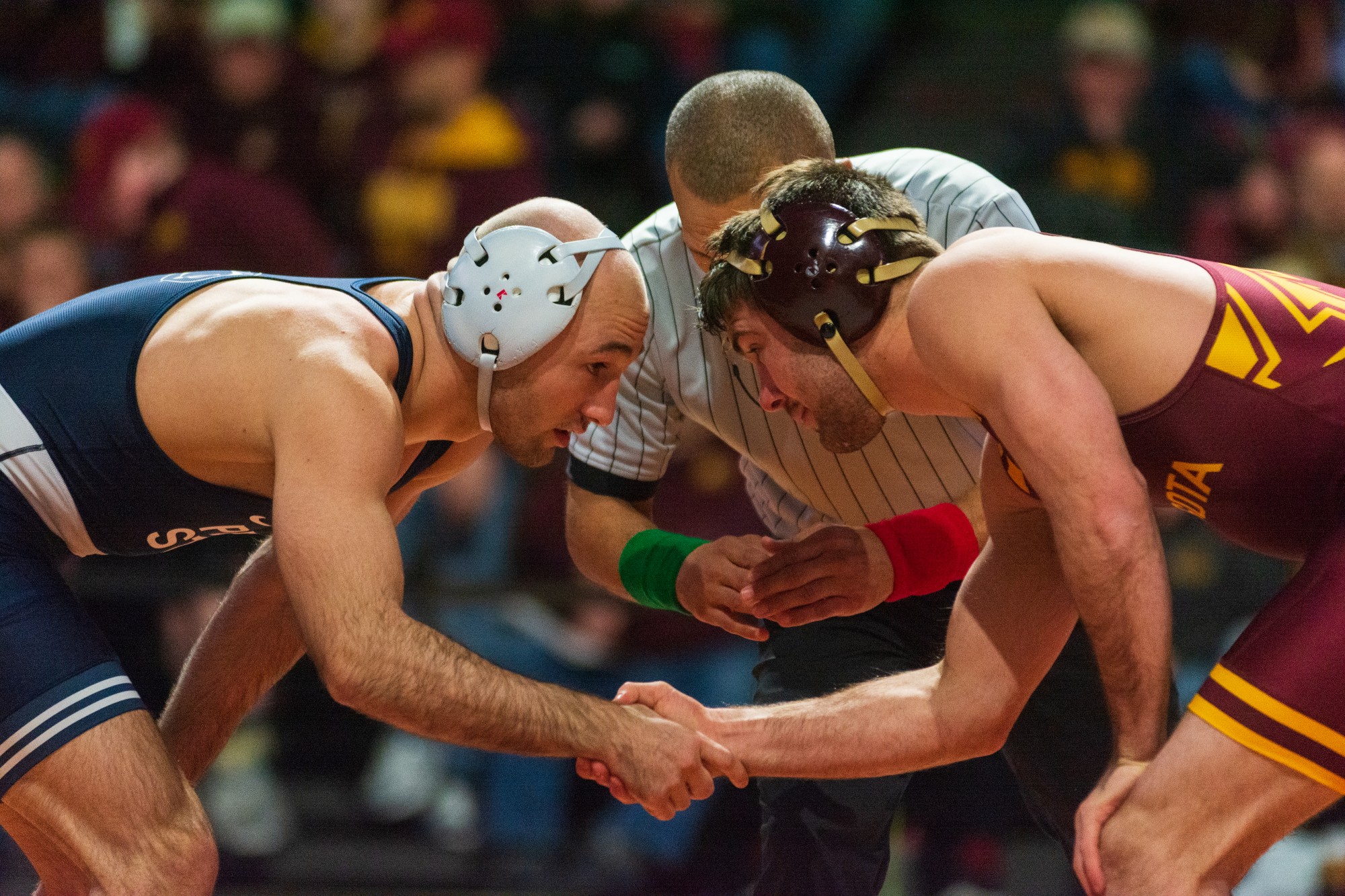 Gophers Redshirt Freshman Brayton Lee shakes his opponents hand before the match at Maturi Pavilion on Sunday, Feb. 9. The Gophers lost to Penn State 31-10. 