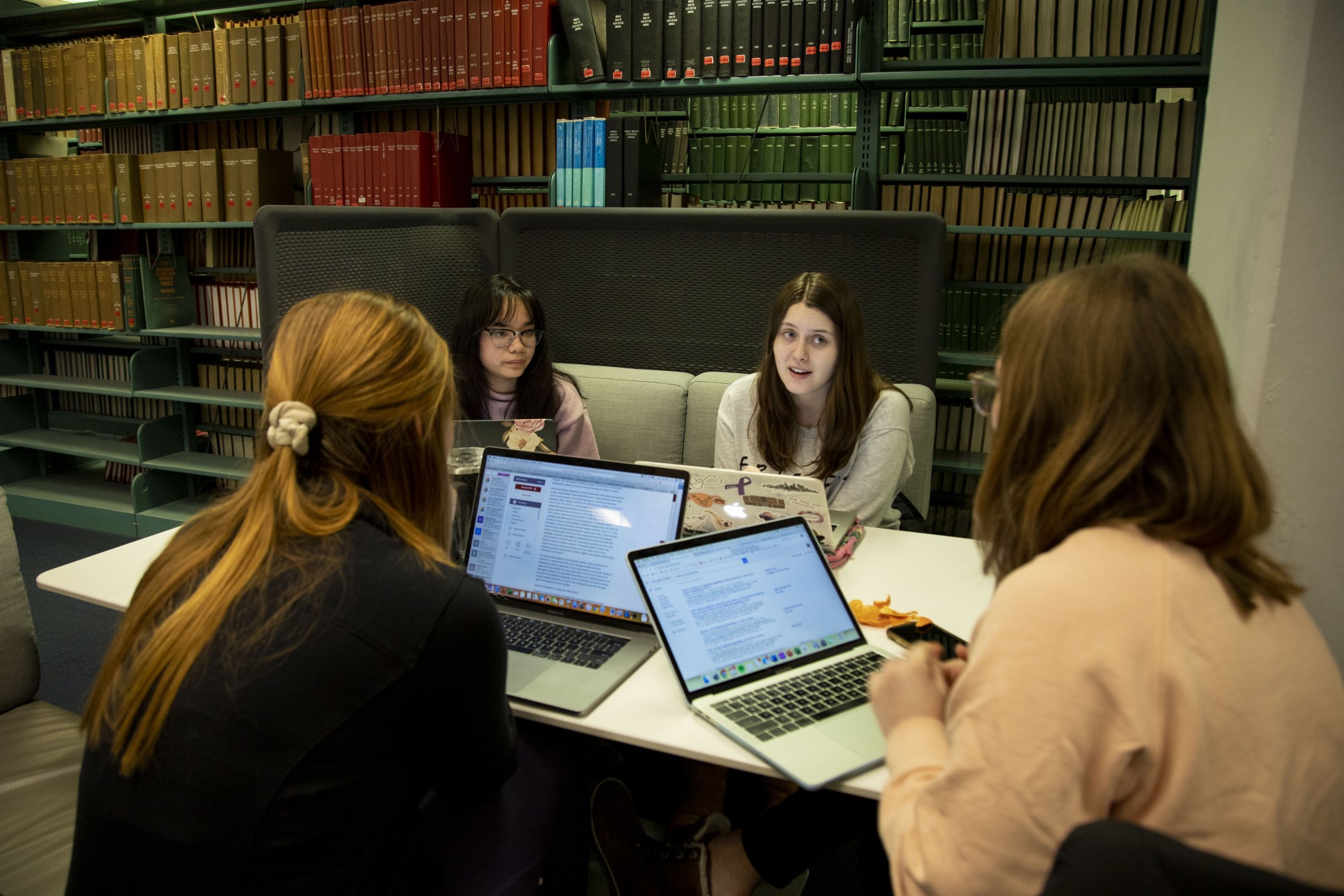 Margaret Moreland, Ann K Pham, Mattea Schubert and Claire Kelley work on a group project in the Biomedical Library on Monday, Feb. 10. 