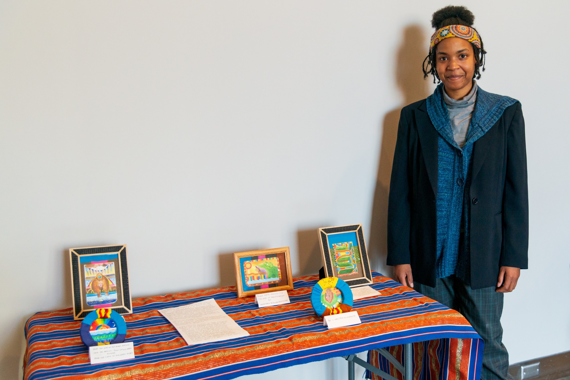 Artist Lauren Evans displays her art in Weisman Art Museum on Saturday, Feb. 15. Yo Mama’s House, an artist, activist and healer cooperative, is celebrating Black History Month and Women’s History Month with this pop-up display. (Emily Urfer / Minnesota Daily)