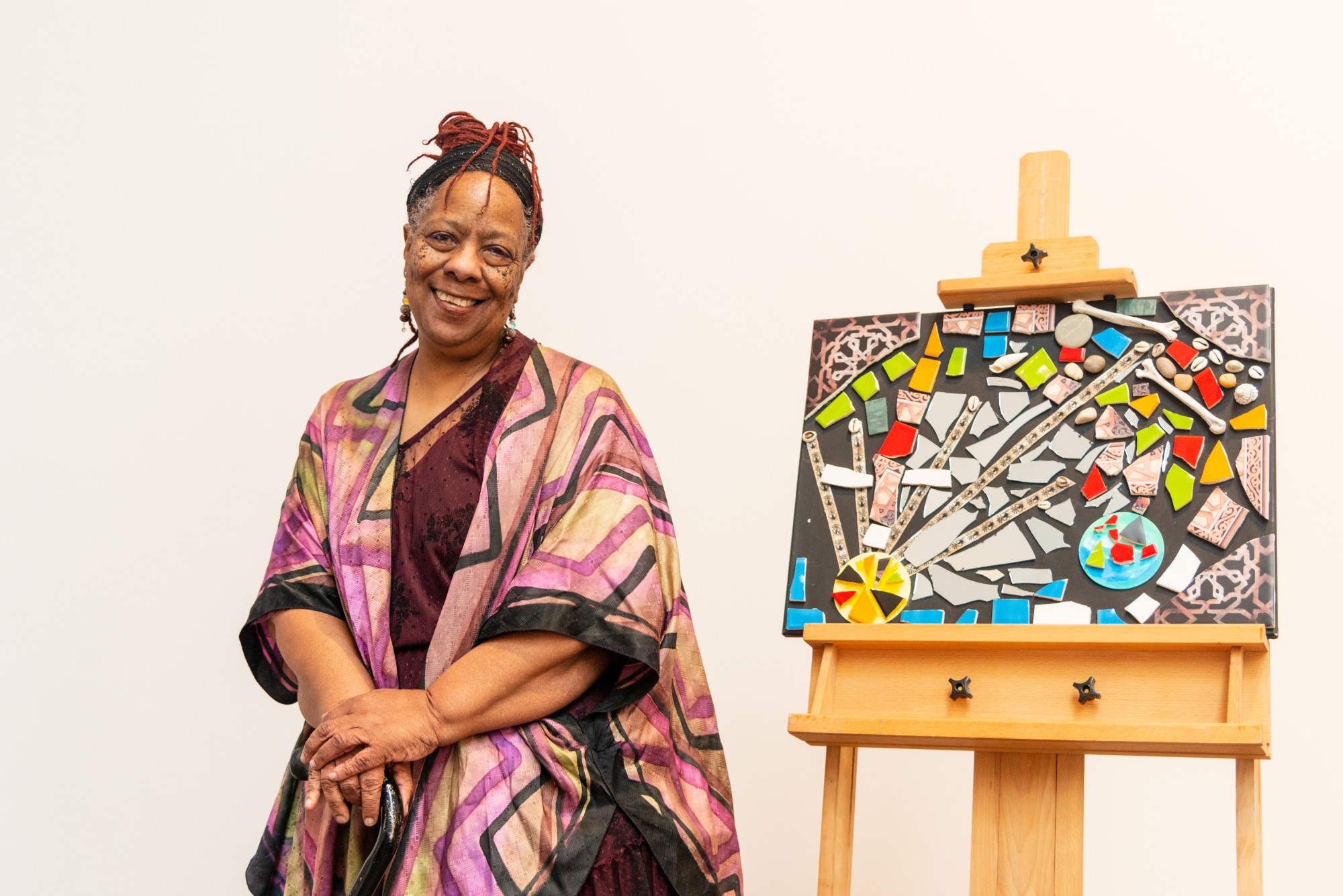 Exhibit Curator Amoke Kubat poses for a portrait in the Weisman Art Museum on Saturday, Feb. 15. Yo Mama’s House, an artist, activist and healer cooperative, is celebrating Black History Month and Women’s History Month with this pop-up display. (Emily Urfer / Minnesota Daily)