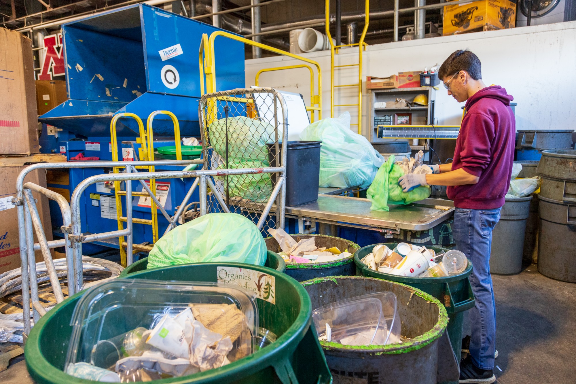 Student Worker Bailey Krolnika sorts through organics recycling from a University residence hall at Como recycling center on Wednesday, Feb. 19.