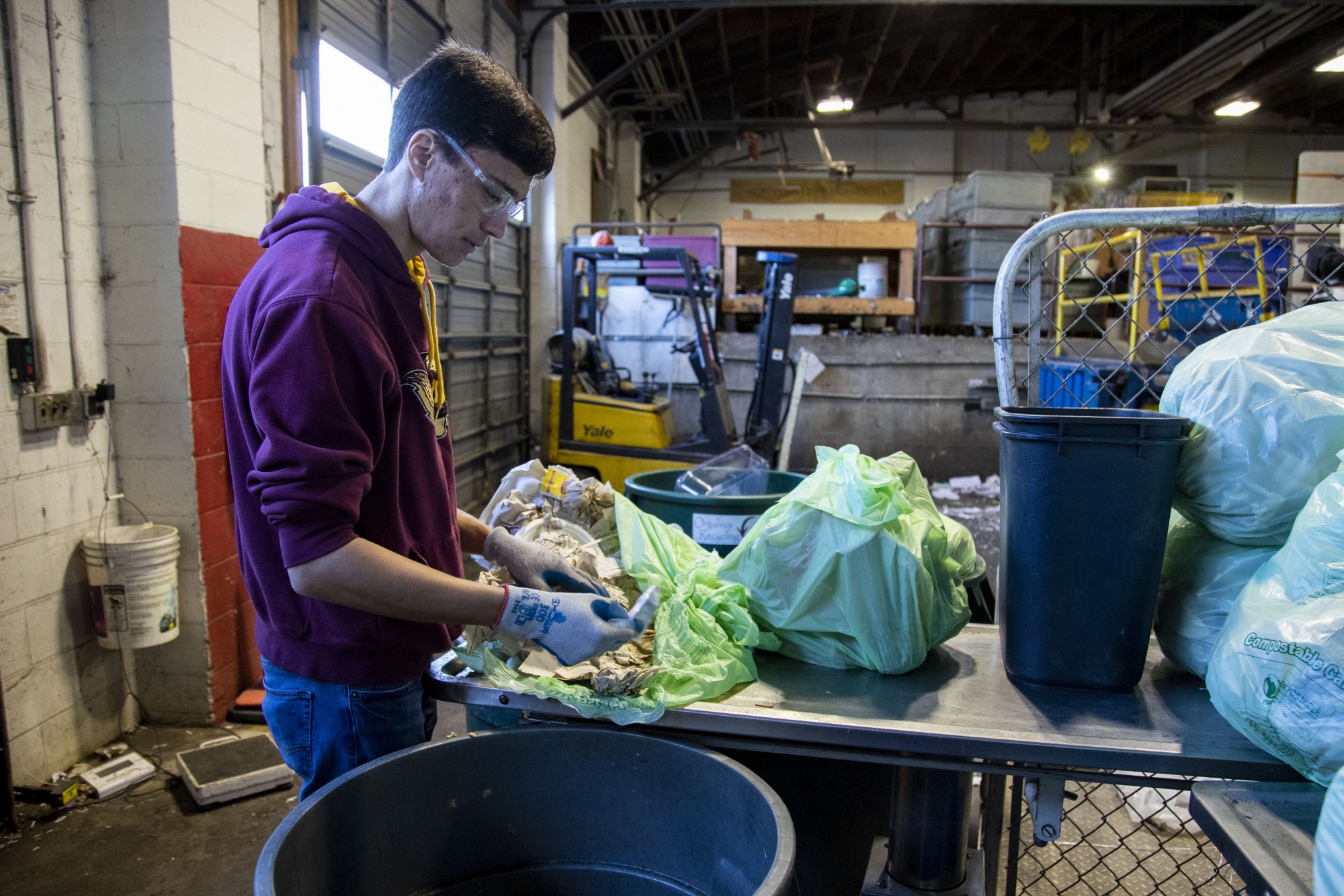 Student Worker Bailey Krolnika sorts through organics recycling from a University residence hall at Como recycling center on Wednesday, Feb. 19. 