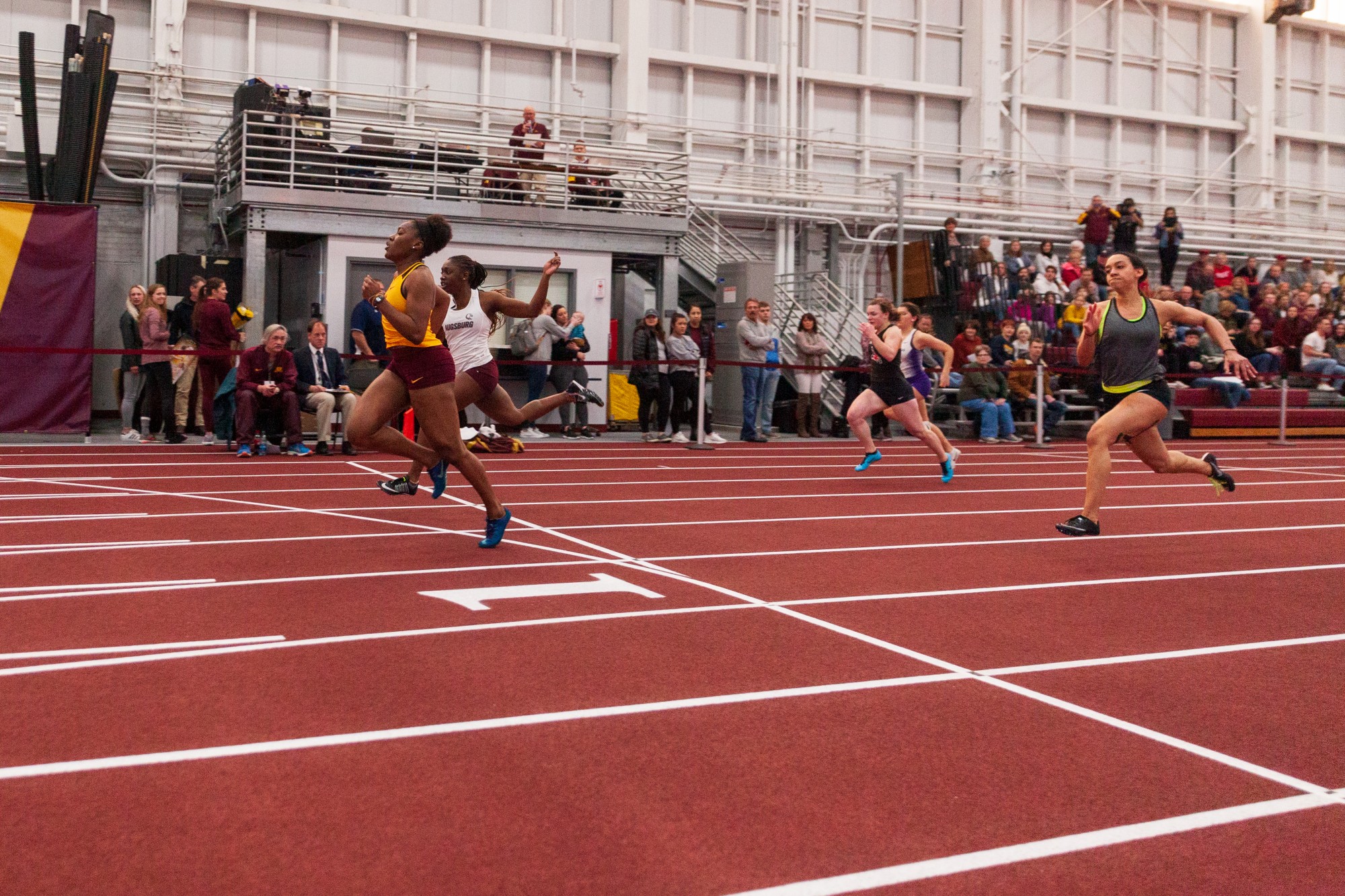 Gophers Freshman Akilah Lewis lunges for the finish line of the sixty meter dash at the Minnesota Cold Classic at the University of Minnesota Fieldhouse on Friday, Feb. 21.