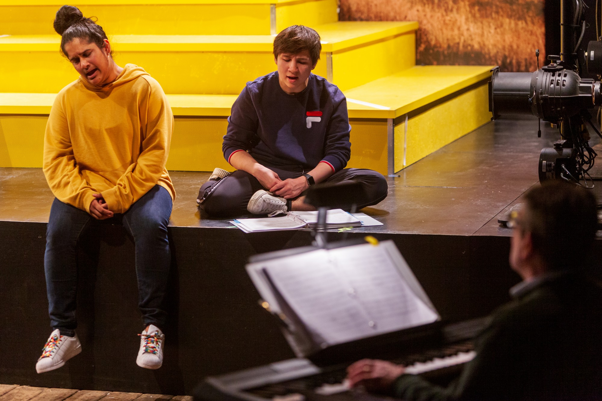 Actors, from left, Sushma Saha and Kai Alexander practice a musical number at during a rehearsal for Interstate at MixedBlood Theatre on Tuesday, Feb. 18. The production, created by Kit Yan and Melissa Li, follows the experiences of two trans people, navigating a myriad of cultural issues.
