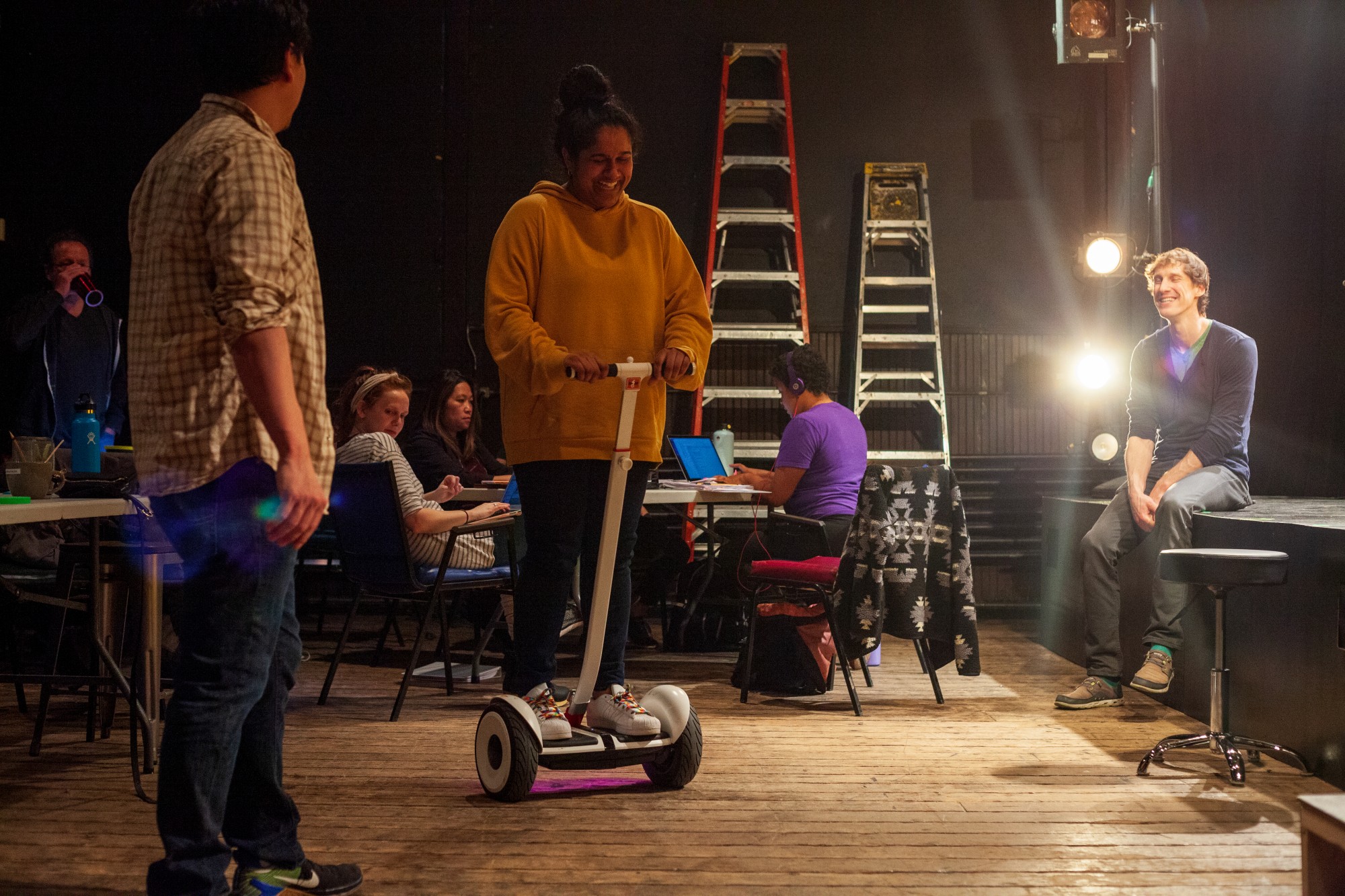 Actress Sushma Saha tries out a new means of transportation during a break at a rehearsal for Interstate at MixedBlood Theatre on Tuesday, Feb. 18. The production, created by Kit Yan and Melissa Li, follows the experiences of two trans people, navigating a myriad of cultural issues. 