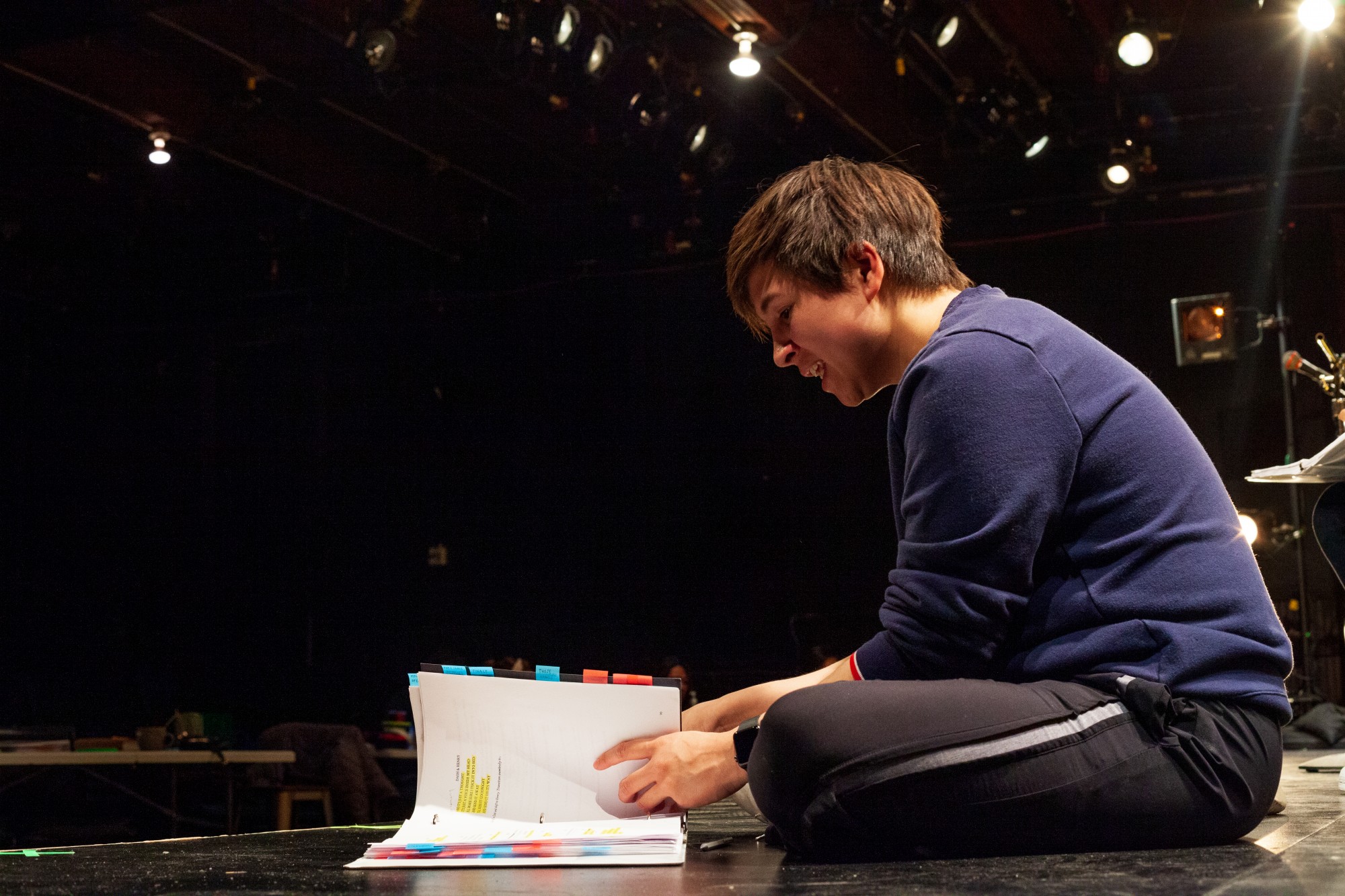 Actor Kai Judd references his notes during a rehearsal for Interstate at MixedBlood Theatre on Tuesday, Feb. 18. The production, created by Kit Yan and Melissa Li, follows the experiences of two trans people, navigating a myriad of cultural issues.