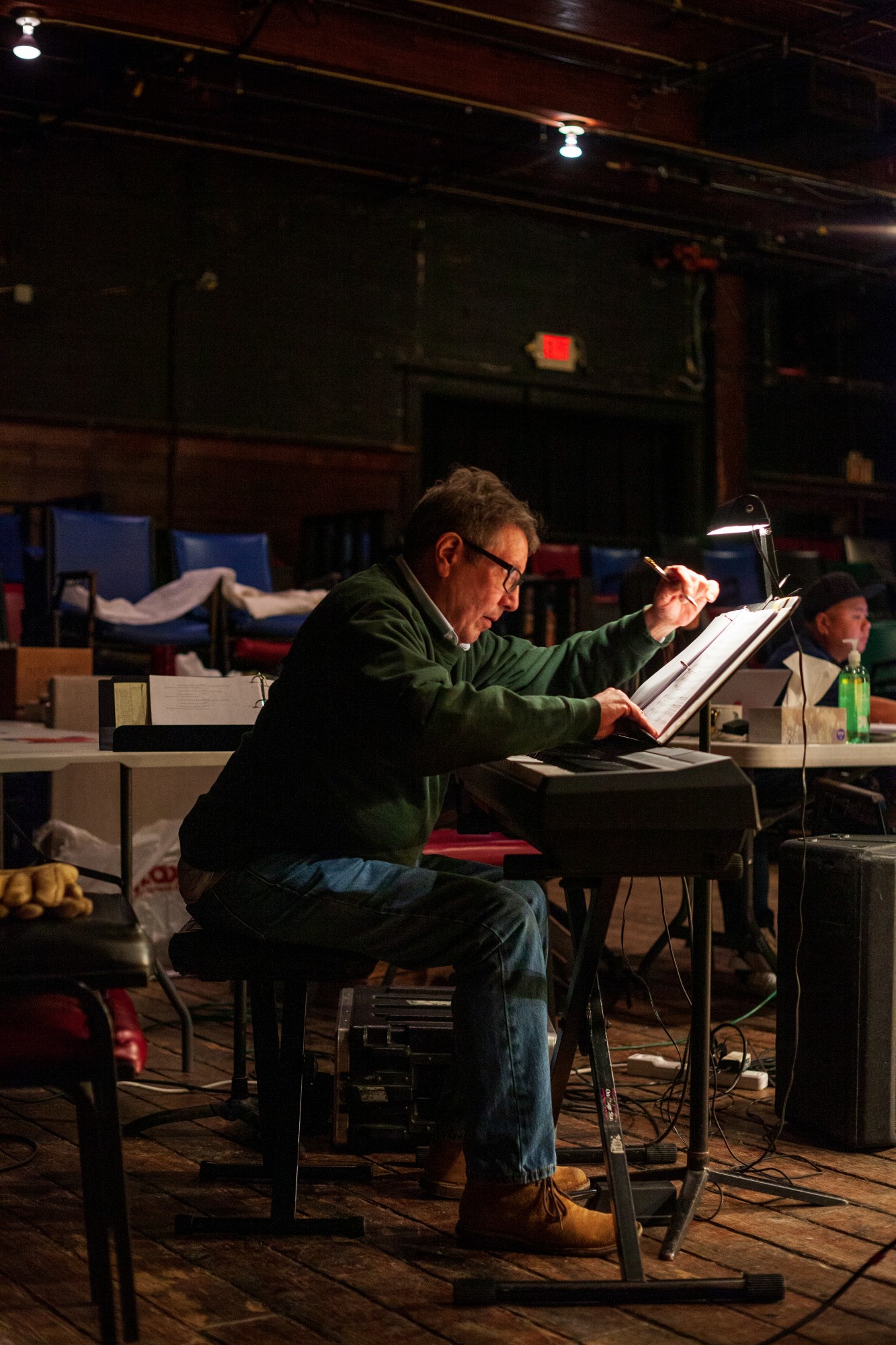 Musician Raymond Berg annotates changes on his sheet music during a rehearsal for Interstate at MixedBlood Theatre on Tuesday, Feb. 18. The production, created by Kit Yan and Melissa Li, follows the experiences of two trans people, navigating a myriad of cultural issues.