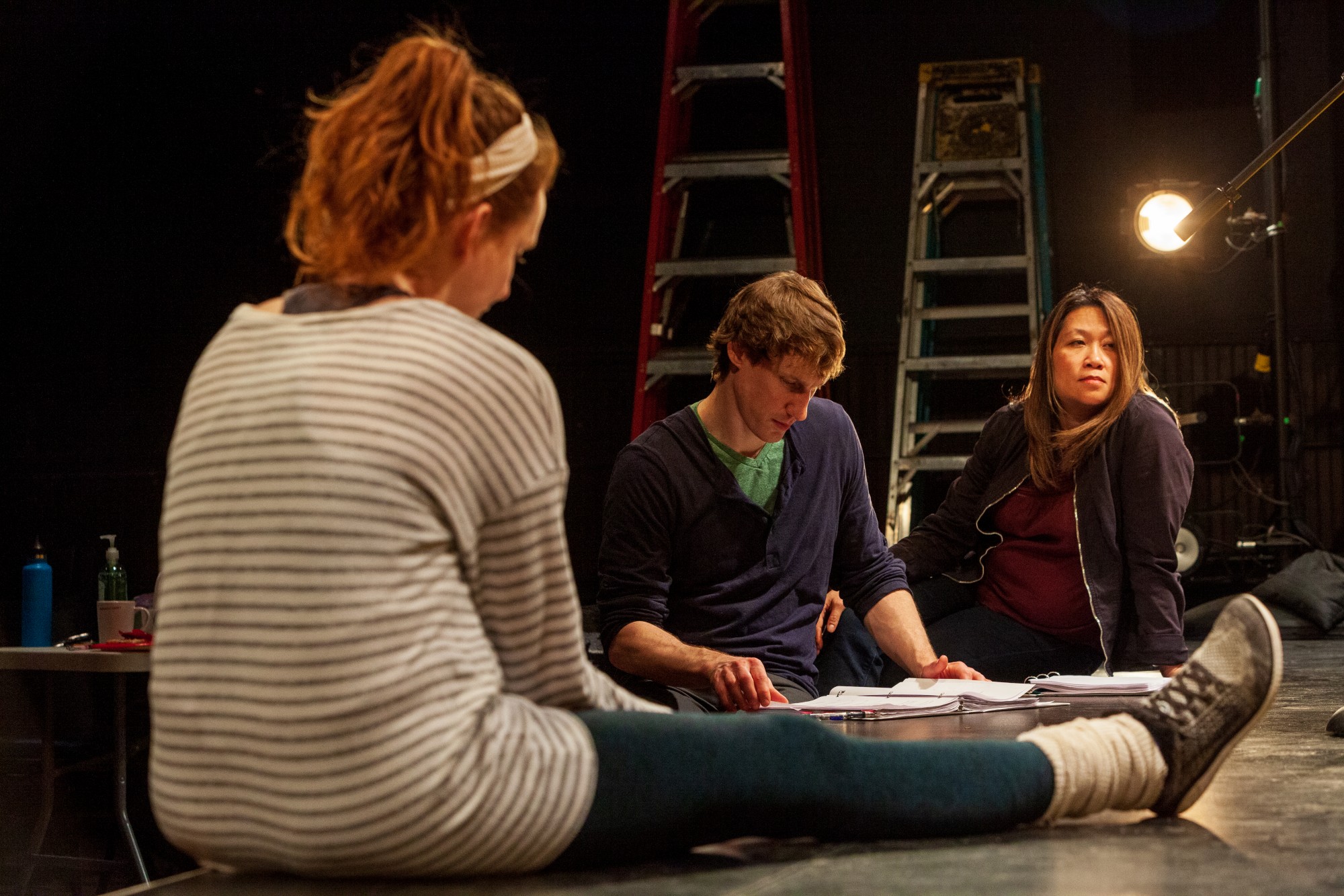 Actors, from left, Meredith Casey, Tom Reed and Lilly Crystal wait for a cue during a rehearsal of Interstate at MixedBlood Theatre on Tuesday, Feb. 18. The production, created by Kit Yan and Melissa Li, follows the experiences of two trans people, navigating a myriad of cultural issues.