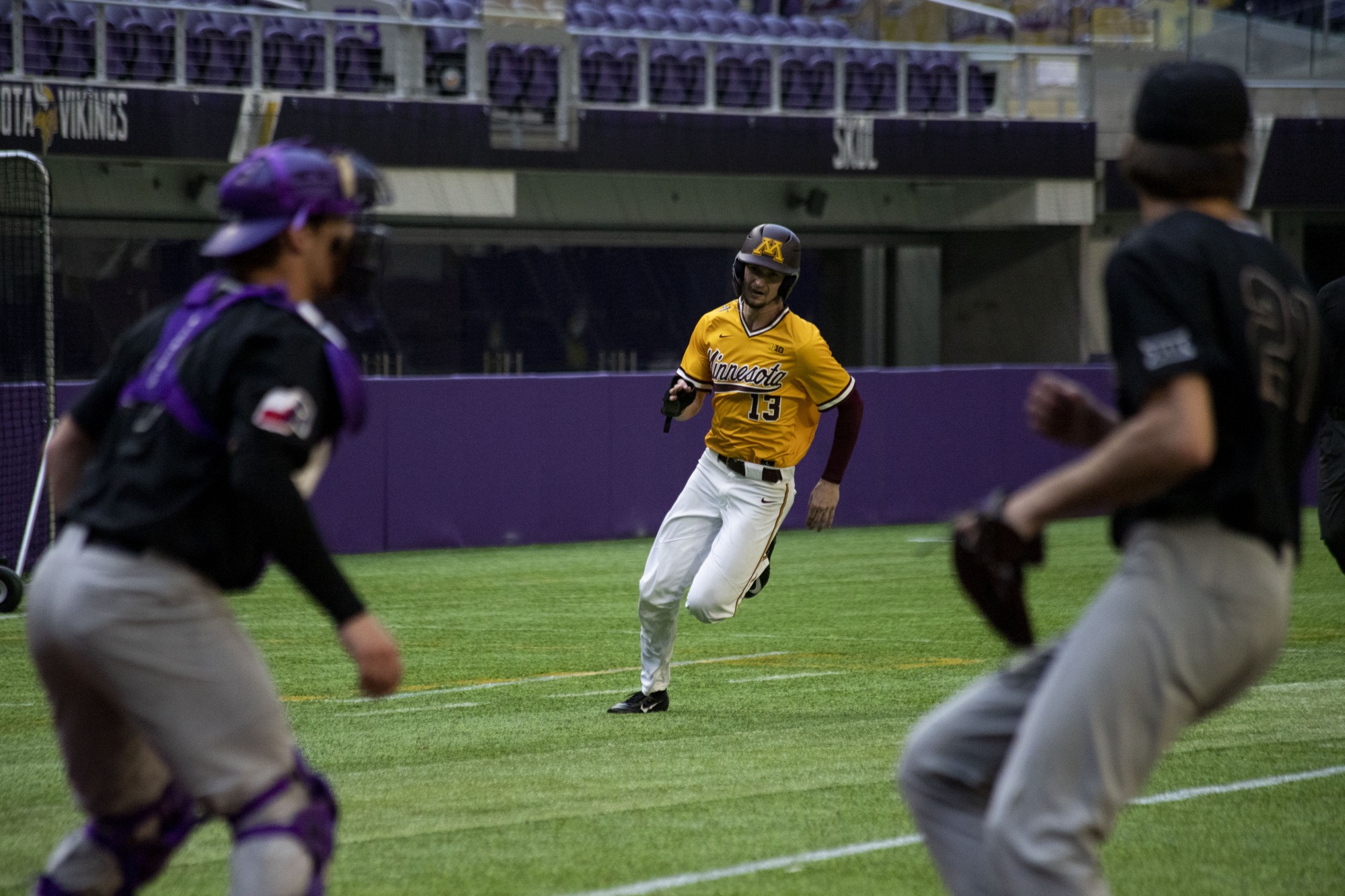 Outfielder Otto Grimm rounds third base during the Gophers 7-6 win against Texas Christian University at U.S. Bank Stadium on Saturday, Feb. 23. 
