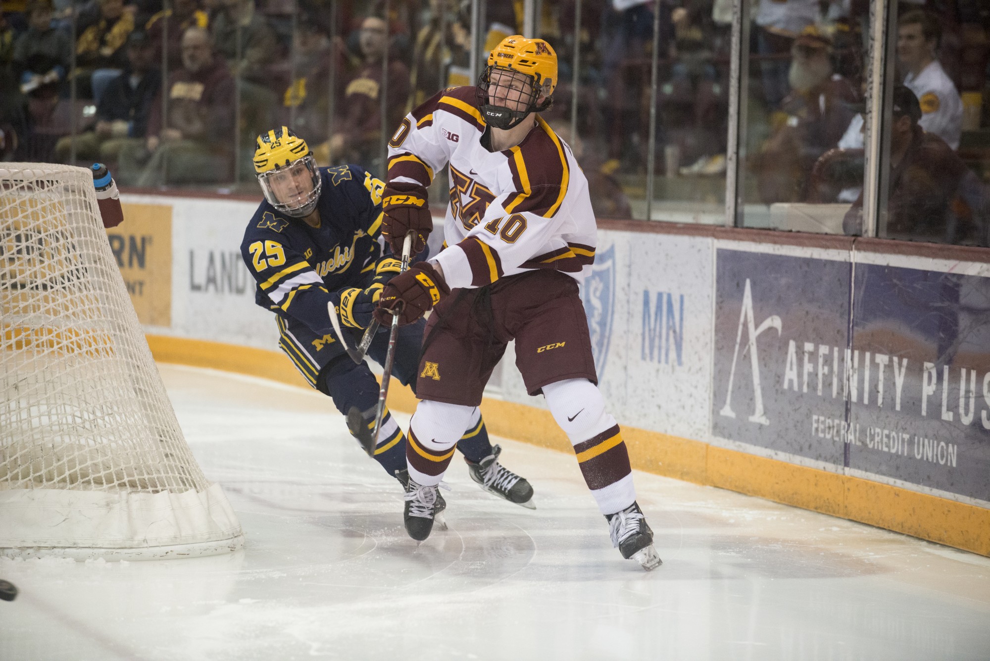 Gophers Defenseman Jackson Lacombe makes a pass at the 3M Arena at Mariucci on Friday, Feb. 28. The Gophers lost to Michigan 3-2.