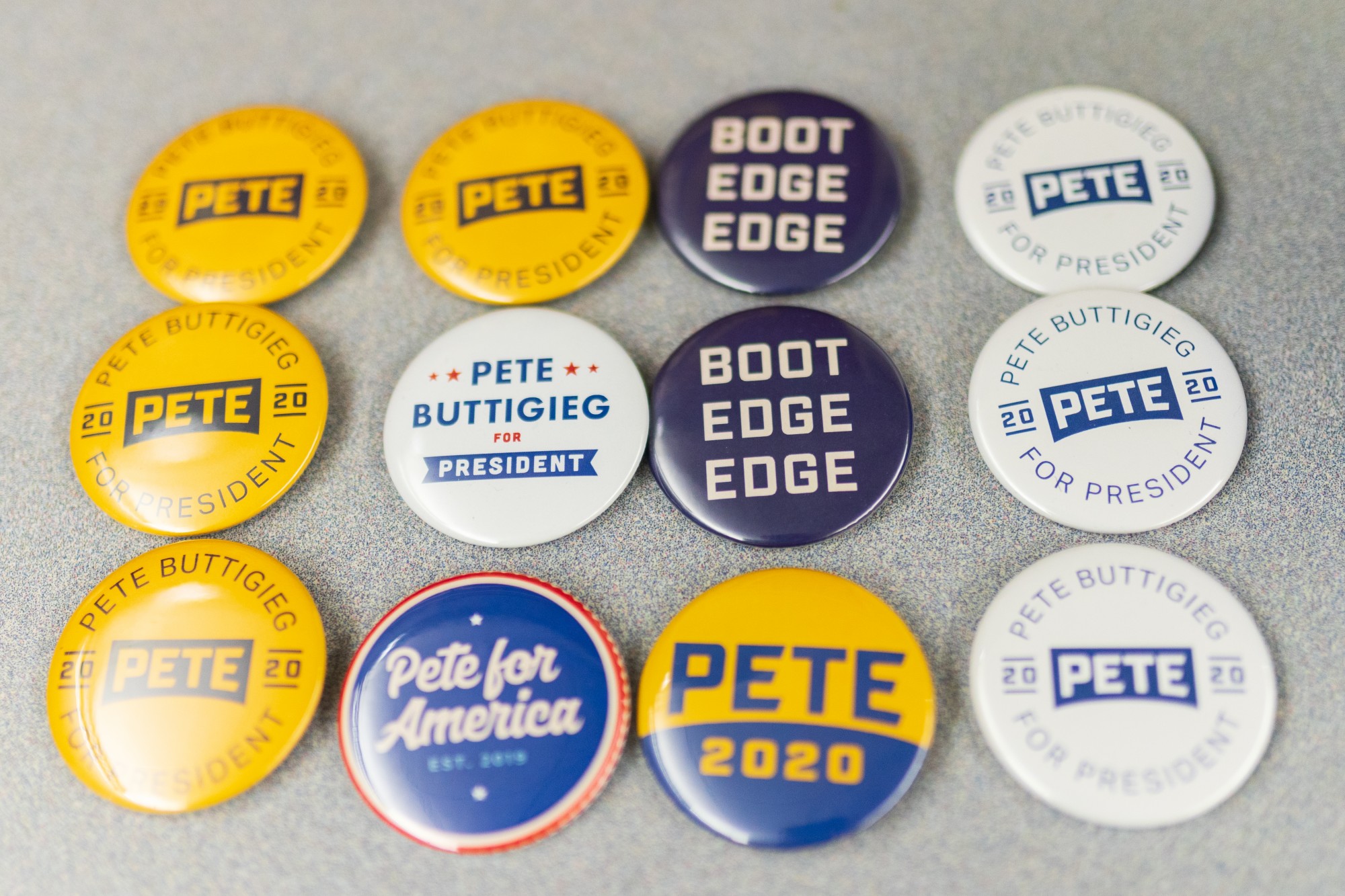 Buttons in support of Democratic presidential candidate Pete Buttigieg are arranged on a table at a phone banking effort in Blegen Hall on Friday, Feb. 28.