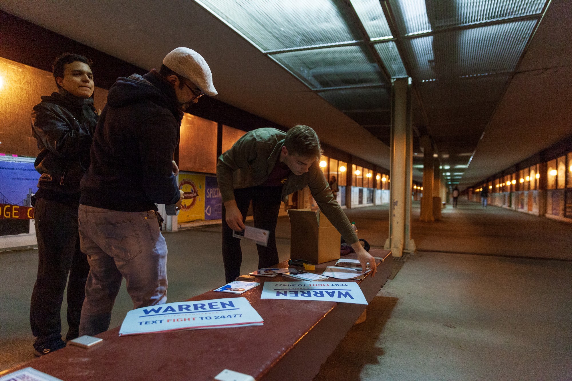 Sophomore Zach Mundt prepares to hang posters in support of Democratic presidential candidate Sen. Elizabeth Warren on the East Bank on Monday, March 2, before Super Tuesday.