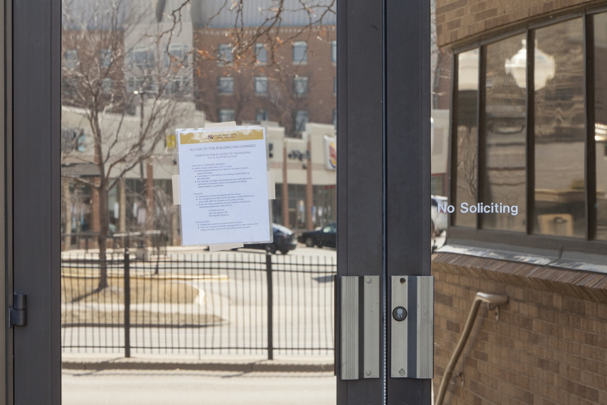 A sign posted on the exterior doors of the office building which houses the Minnesota Dailys offices announces changes to access on Saturday, March 21.