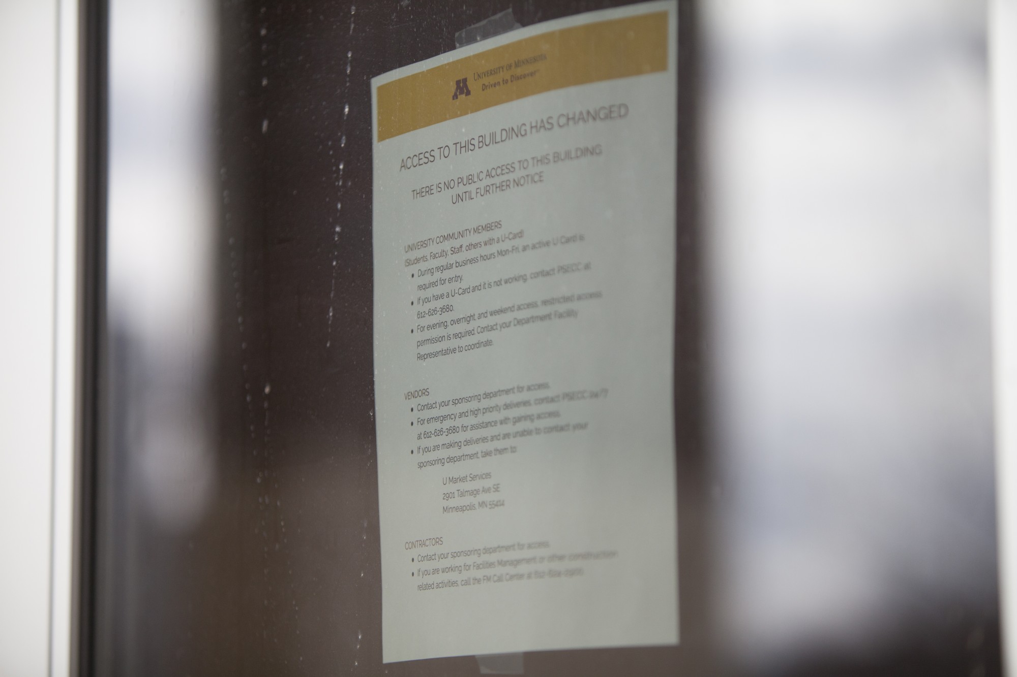 A notice of changes to access is posted on a door of TCF Bank Stadium on Saturday, March 21.