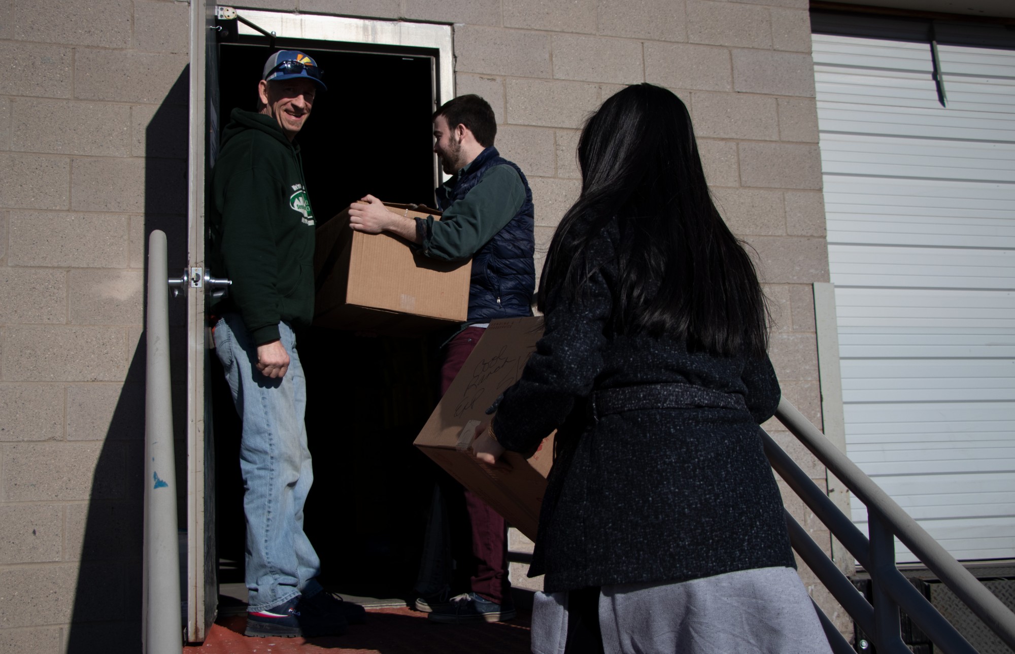 Matt Anderson, Loaves & Fishes director of sites, greets Will Bergstrom and Priscilla Trinh who are bringing about 40 lbs of rescued food to the Loaves & Fishes warehouse in Minneapolis on Friday, Feb. 28. 