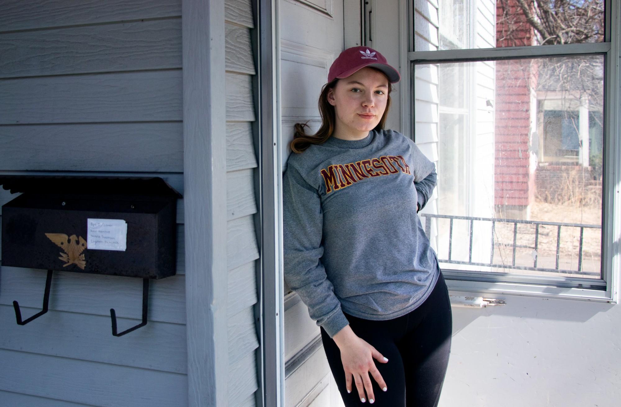 Third-year student Natalie Swanson poses for a portrait at the house she rents in Marcy-Holmes on Wednesday, April 1. Swanson was laid off from her job at a coffee shop that stopped operation in response to COVID-19. Though her landlord has lowered rent by $100 per person, she is uncertain about her ability to make rent after April. 