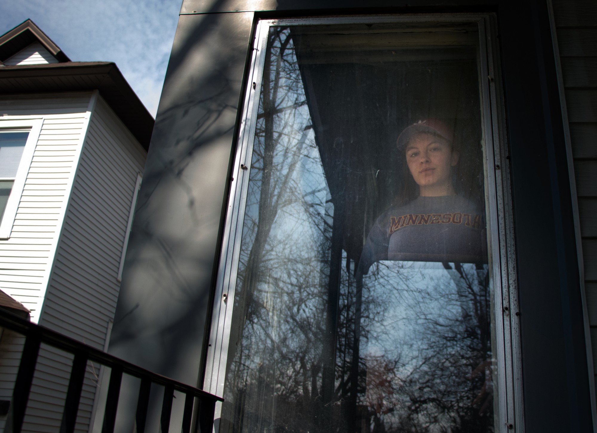 Third-year student Natalie Swanson poses for a portrait at the house she rents in Marcy-Holmes on Wednesday, April 1. Swanson was laid off from her job at a coffee shop that stopped operation in response to COVID-19. Though her landlord has lowered rent by one hundred dollars per person, she is uncertain about her ability to make rent after April. 