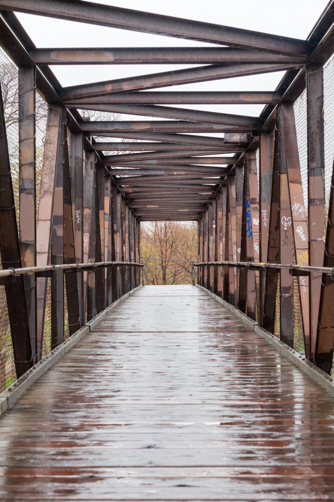 A pedestrian bridge near the Como neighborhood is drenched by an afternoon shower on Tuesday, April 28.