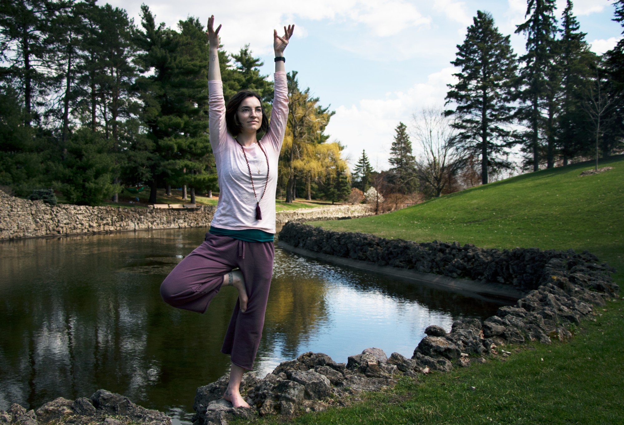 Tessa Jonson performs the Tree pose in Como Regional Park on Monday, April 27. Rose instructs both traditional yoga and meditation based classes online. In her teaching, Rose believes that the mental aspects of yoga are often more important than the physical. 