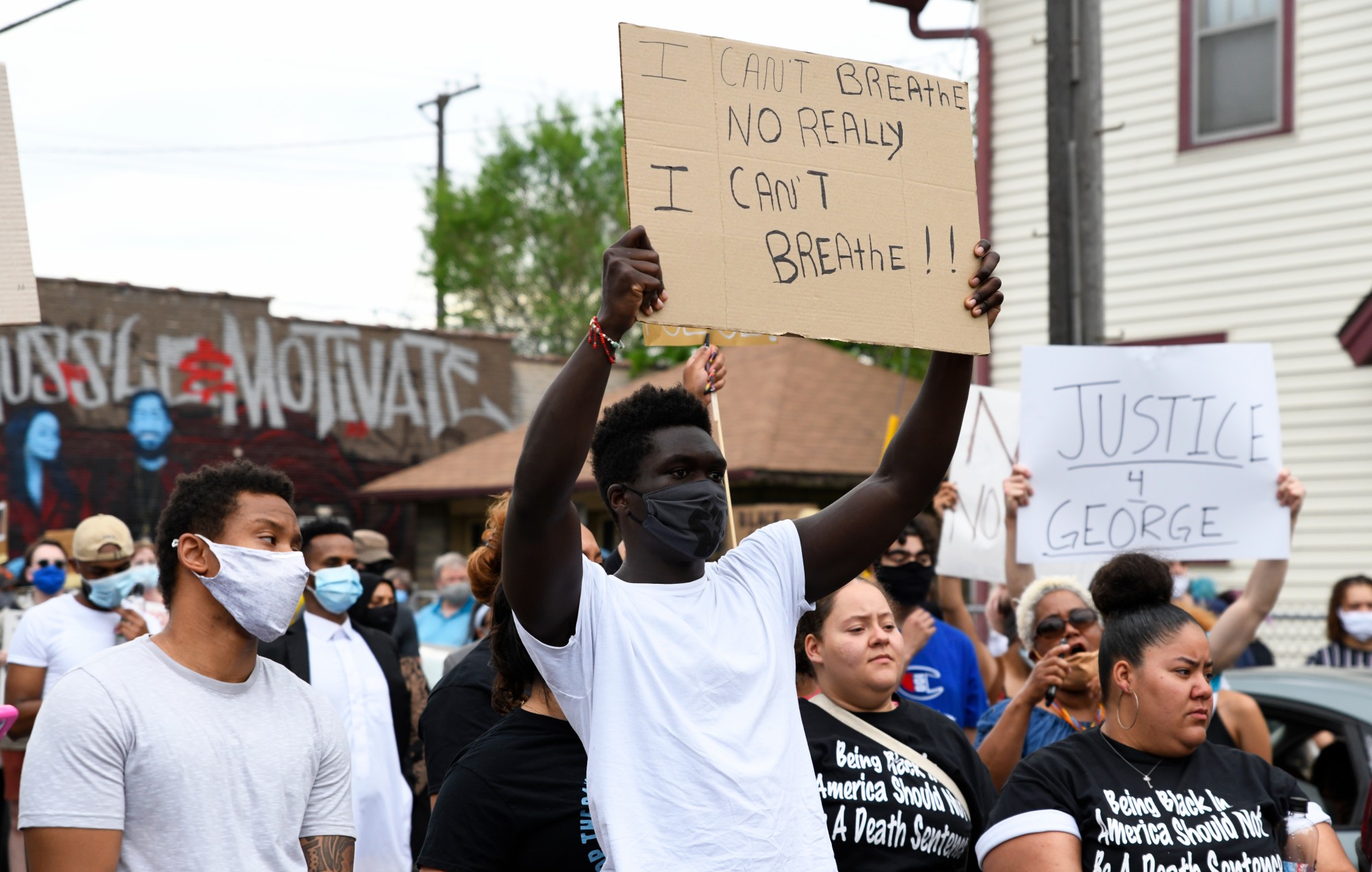 Protesters hold signs as they begin to march from Cup Foods on Chicago Avenue South in Minneapolis to the Minneapolis 3rd Police Precinct on Minnehaha Avenue on Tuesday, May 26. The protest was in response to the death of George Floyd in police custody. 