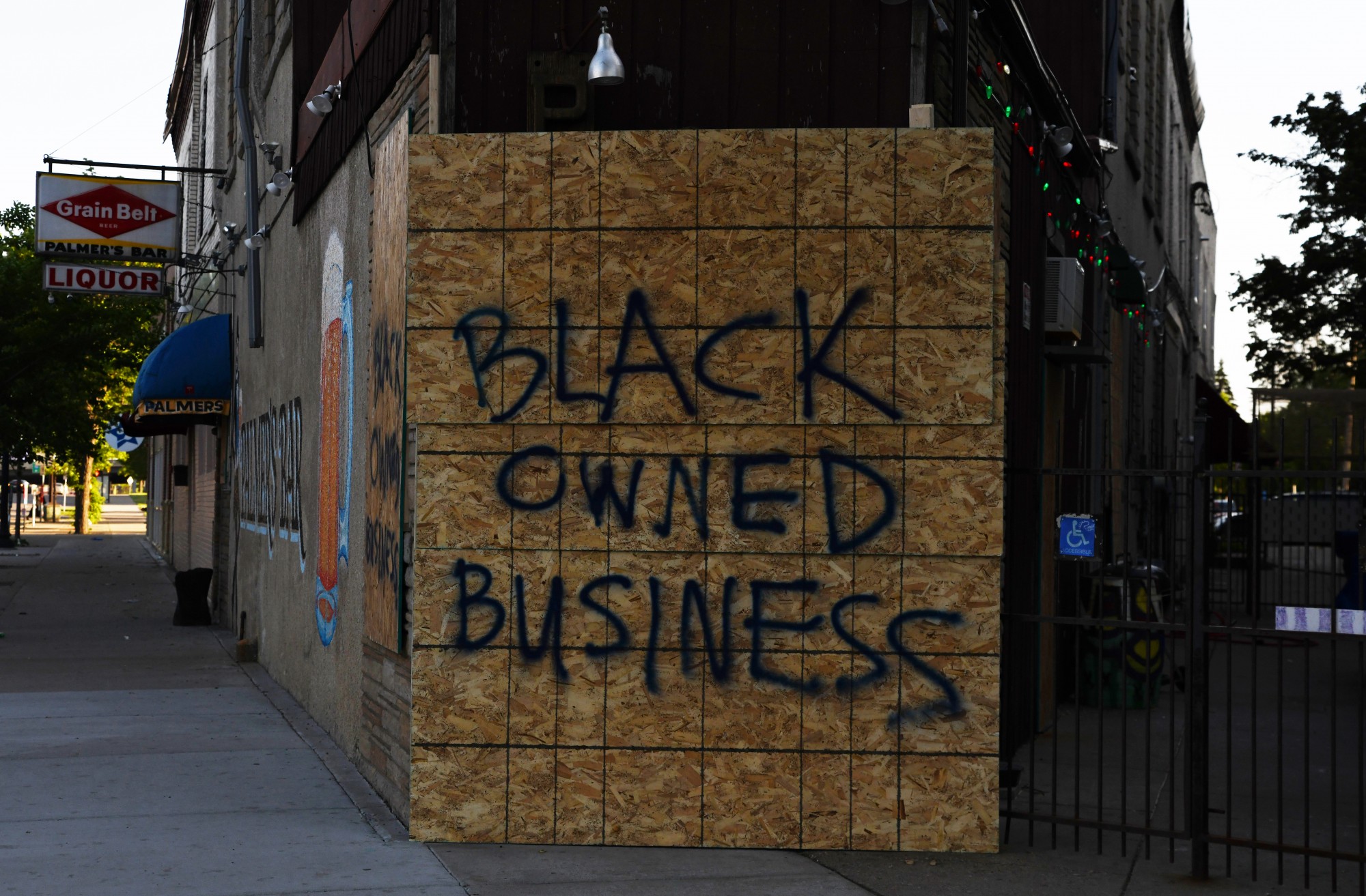 The windows of Palmer’s Bar sit boarded up and painted with the phrase “Black Owned Business” on Thursday, May 28 in the Cedar-Riverside neighborhood. 