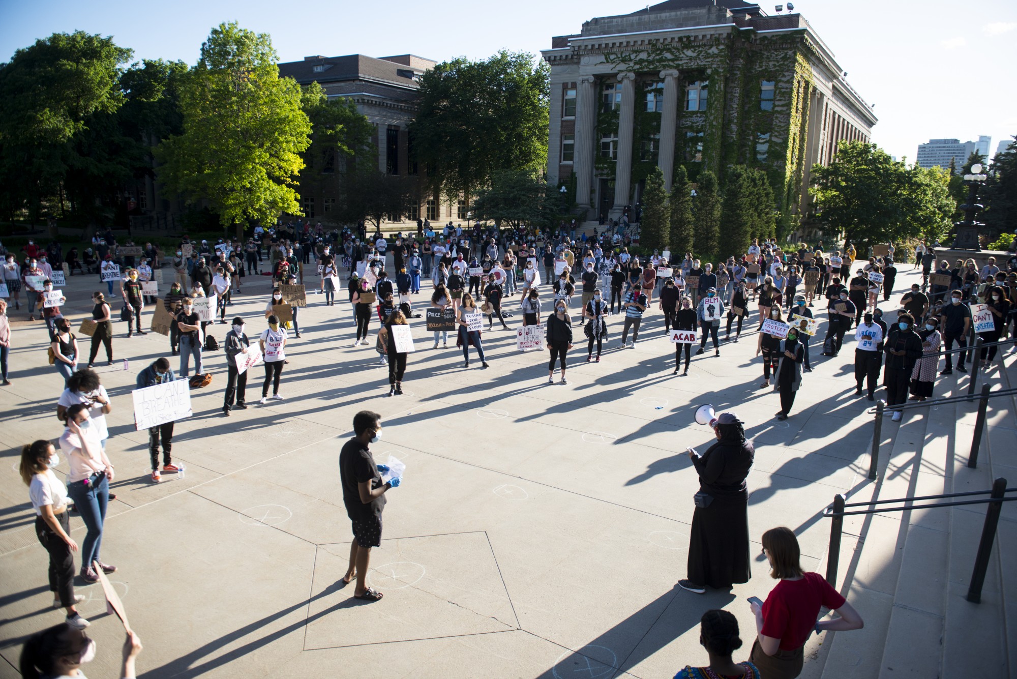 Student demonstrators gather outside of Northrup Auditorium on Friday, May 29 to protest the killing of George Floyd and the Minneapolis Police Department. Chalk marks were drawn 6-feet apart to help the crowd with social distancing. 