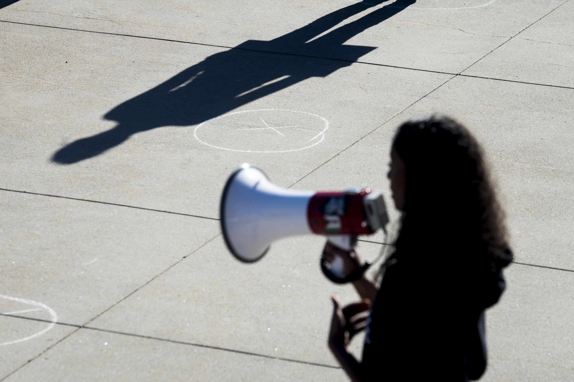 Sumaya Aden speaks to student demonstrators outside of Northrup Auditorium on Friday, May 29 to protest the killing of George Floyd and the Minneapolis Police Department. Adens brother, Isak, was killed by police last July. Chalk marks were also drawn 6-feet apart to help the crowd with social distancing. 