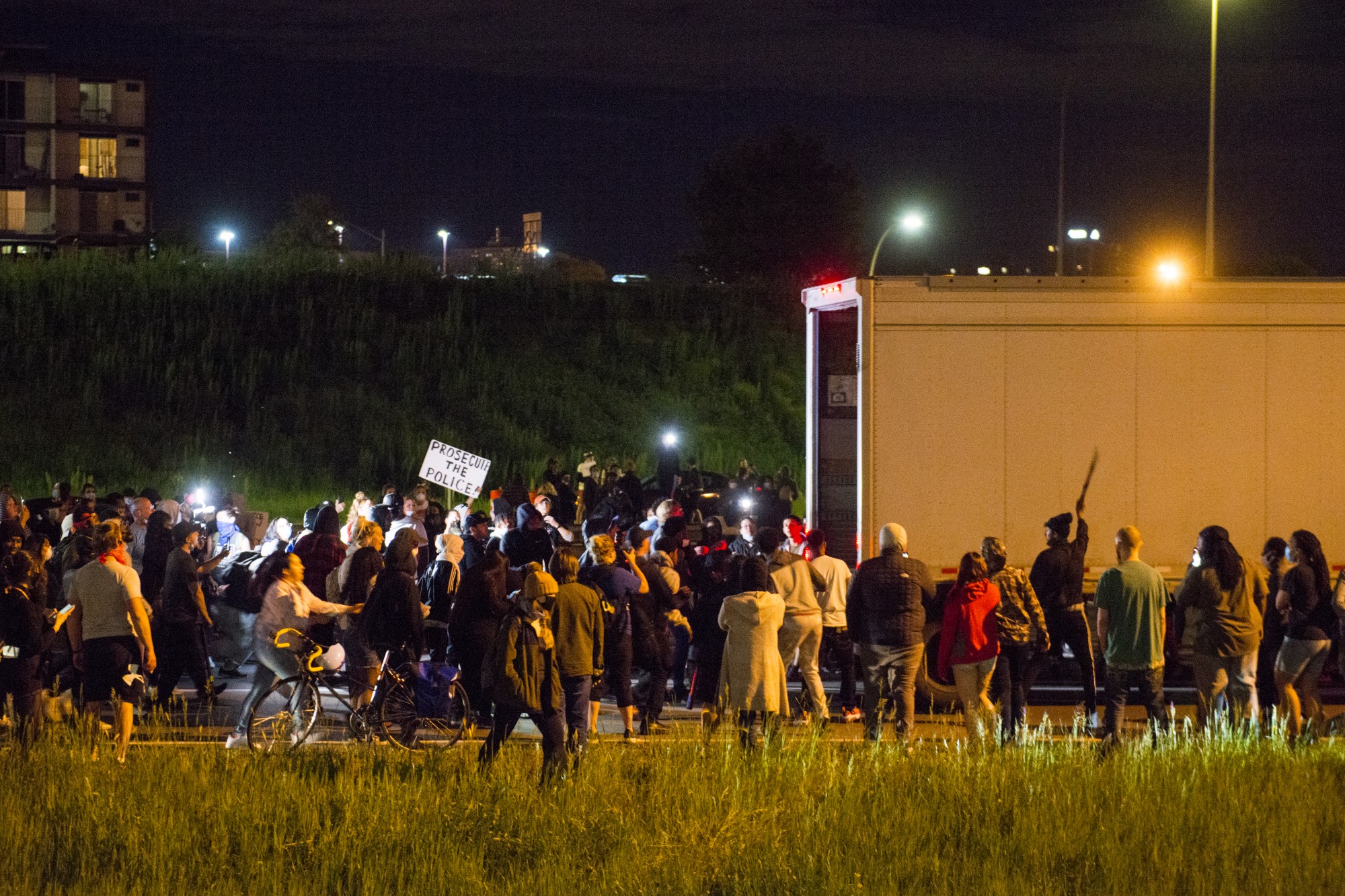 Protesters block I-35W and attempt to pull items from the back of a UPS truck on Friday, May 29. 