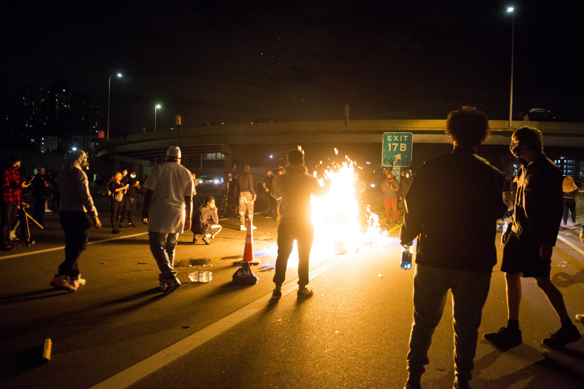 Protestors attempt to block traffic and light a fire on Interstate 35W on Friday, May 29.