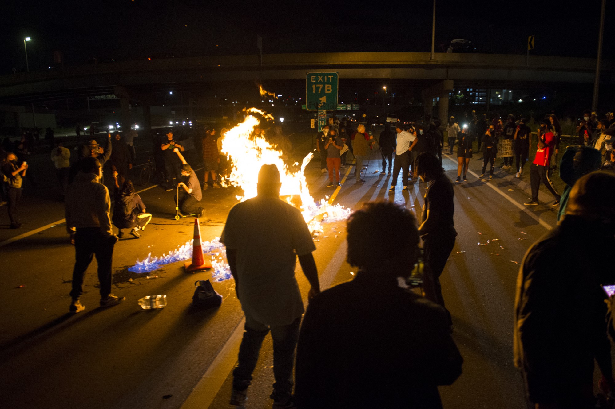 Protestors attempt to block traffic and light a fire on Interstate 35W on Friday, May 29. 