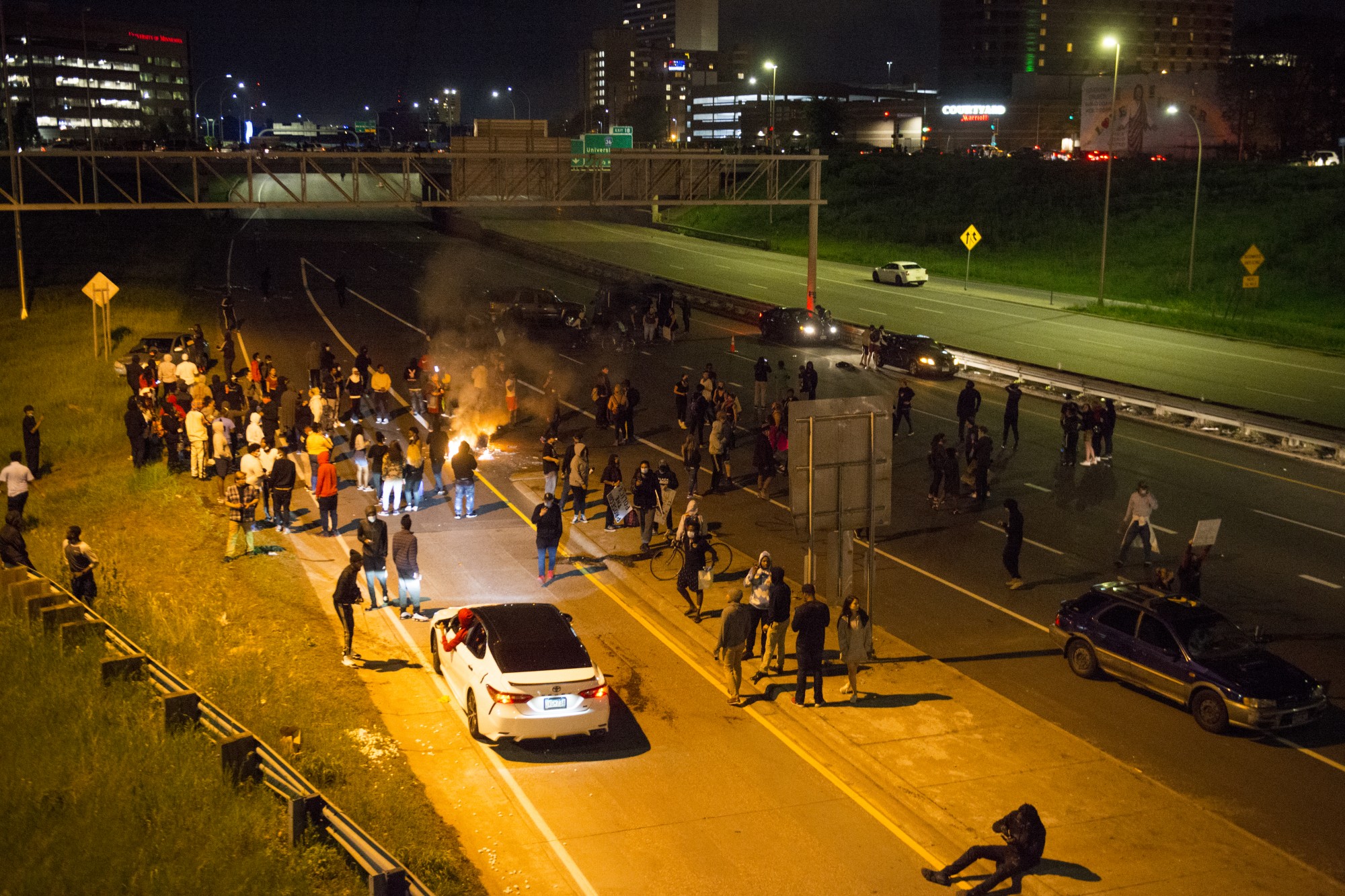 Protestors attempt to block traffic and light a fire on Interstate 35W on Friday, May 29. 
