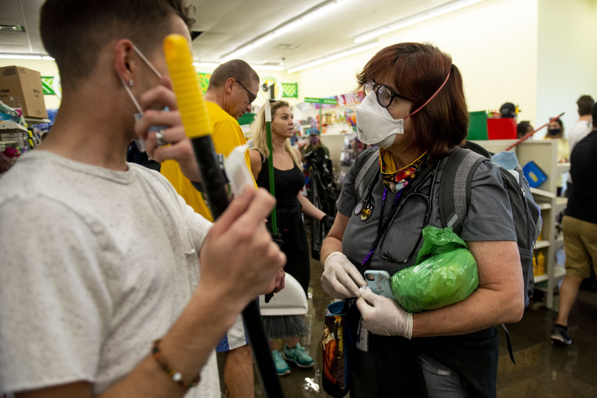 Dr. Vivian Fischer tends to volunteers with band-aids, Tylenol and masks inside Dollar Tree near the Minneapolis 5th precinct following another night of riots on Friday. Fischer expects to transition from first aid assistance to mental health over the coming weeks as unrest in Minneapolis continues. 