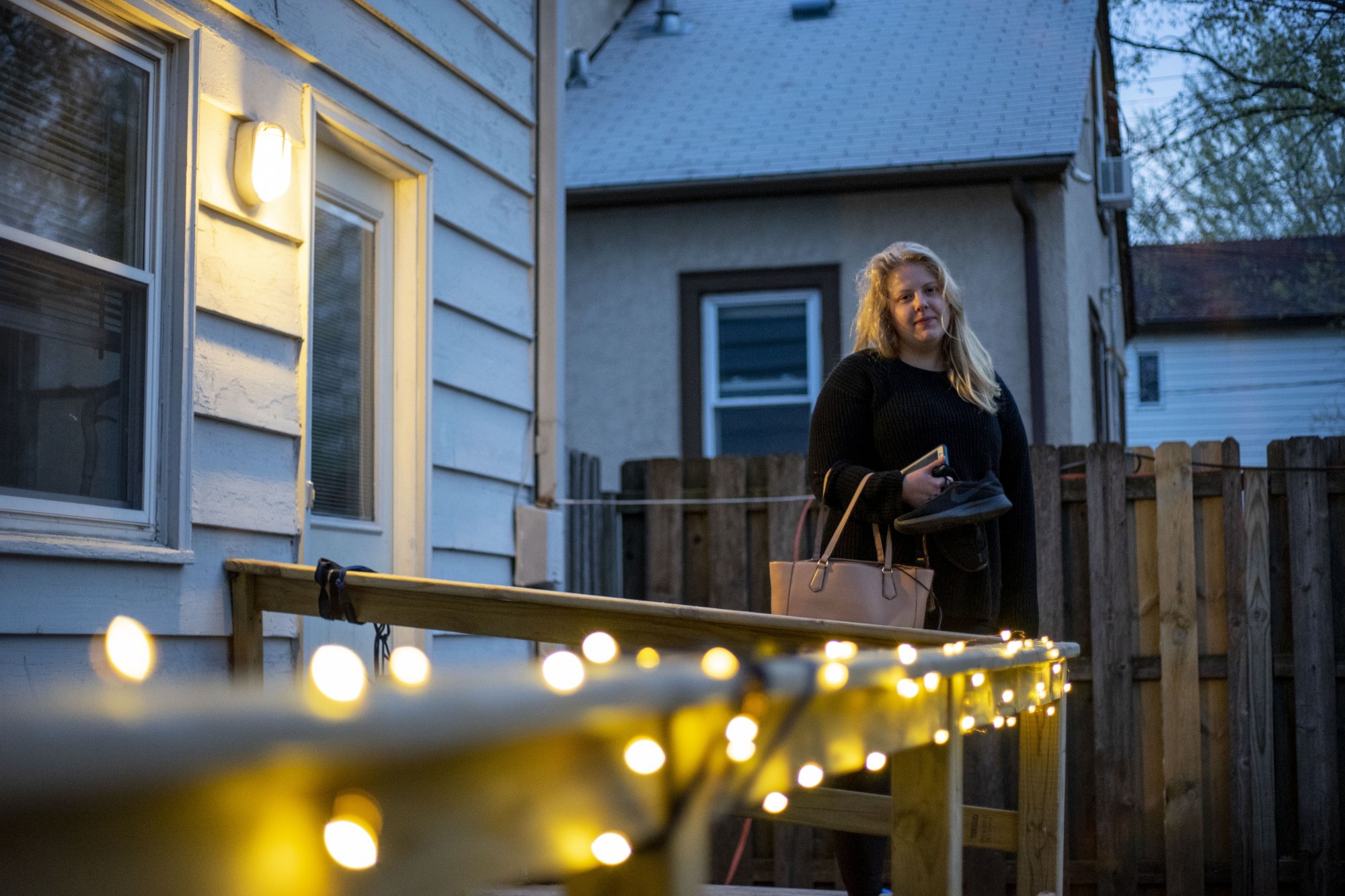 5:47 a.m.
Im grateful honestly, said Emily Koenig who poses for a portrait outside of her home before leaving for work at ACR Homes. I would be going crazy, she said. The people I work with and take care of are like a second little family. (Jack Rodgers / Minnesota Daily)


