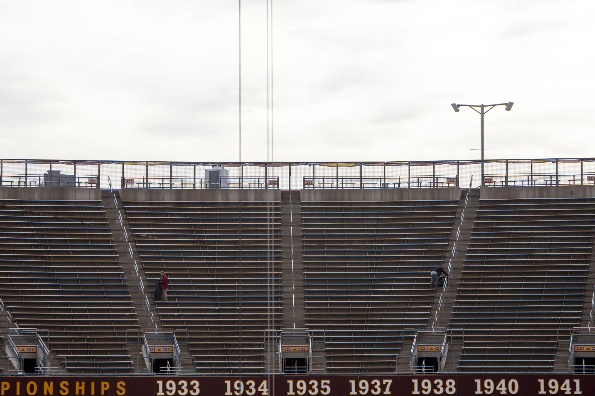 9:26 a.m.
Two workers are seen in the empty stands of TCF Bank Stadium. 