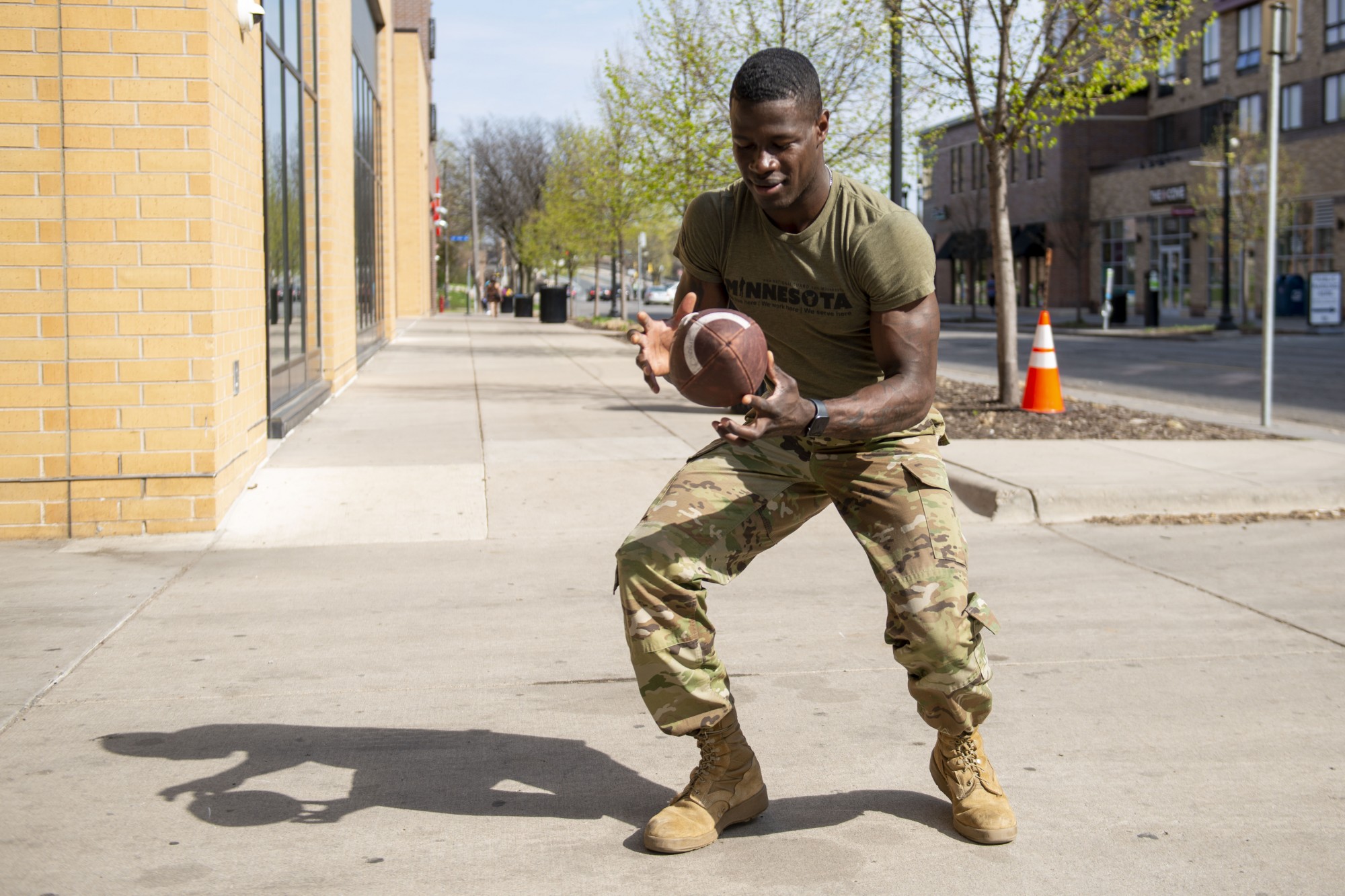 4:27 p.m.
National Guard Sergeant Yves Spies catches a football outside of the Armed Services recruiting center where he works in Dinkytown. 