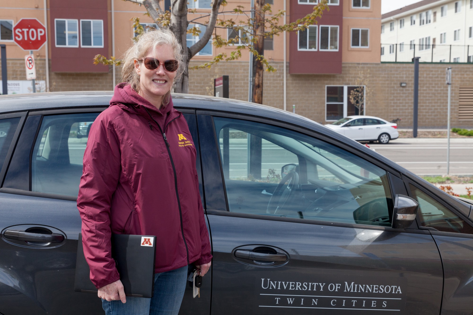 University Landcare Supervisor Emily Marin poses for a portrait beside her car, from which she now does most of her work on Thursday, May 7.