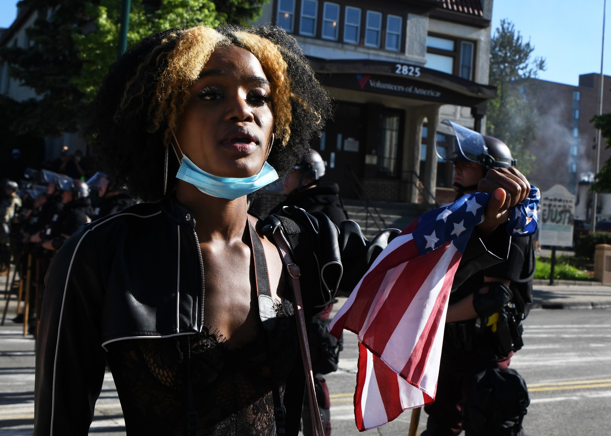 Akilha Venzant holds an American flag while addressing law enforcement on East Lake Street near the Minneapolis 3rd Police Precinct on Friday, May 29. While the crowd of demonstrators chanted “Black Lives Matter,” Venzant addressed each officer individually, saying: “Black lives matter. They do. They really do.”