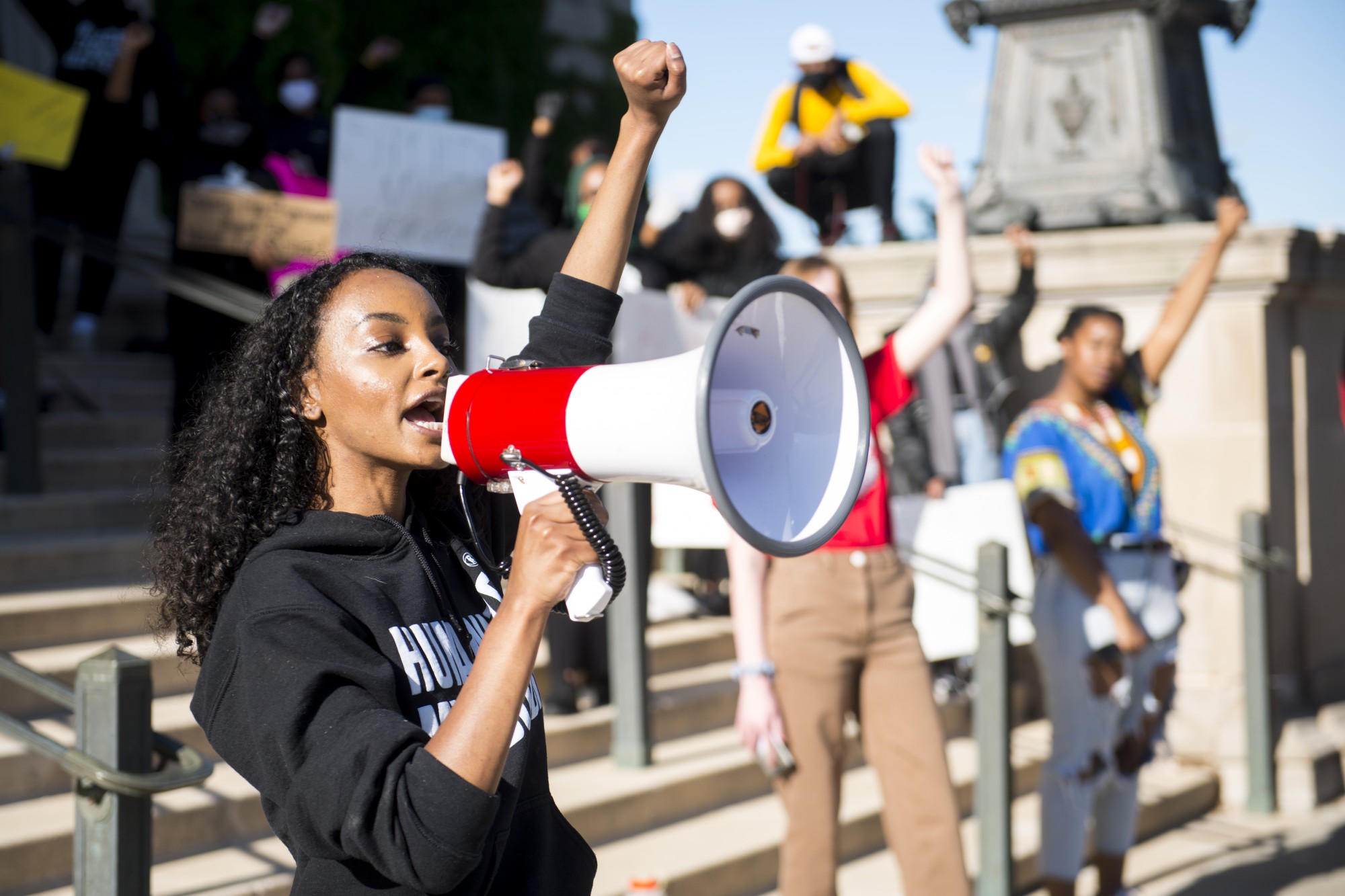 Sumaya Aden speaks to student demonstrators outside of Northrup Auditorium on Friday, May 29 to protest the killing of George Floyd and the Minneapolis Police Department. Adens brother, Isak, was killed by police last July. Chalk marks were also drawn 6-feet apart to help the crowd with social distancing. (Jack Rodgers / Minnesota Daily)