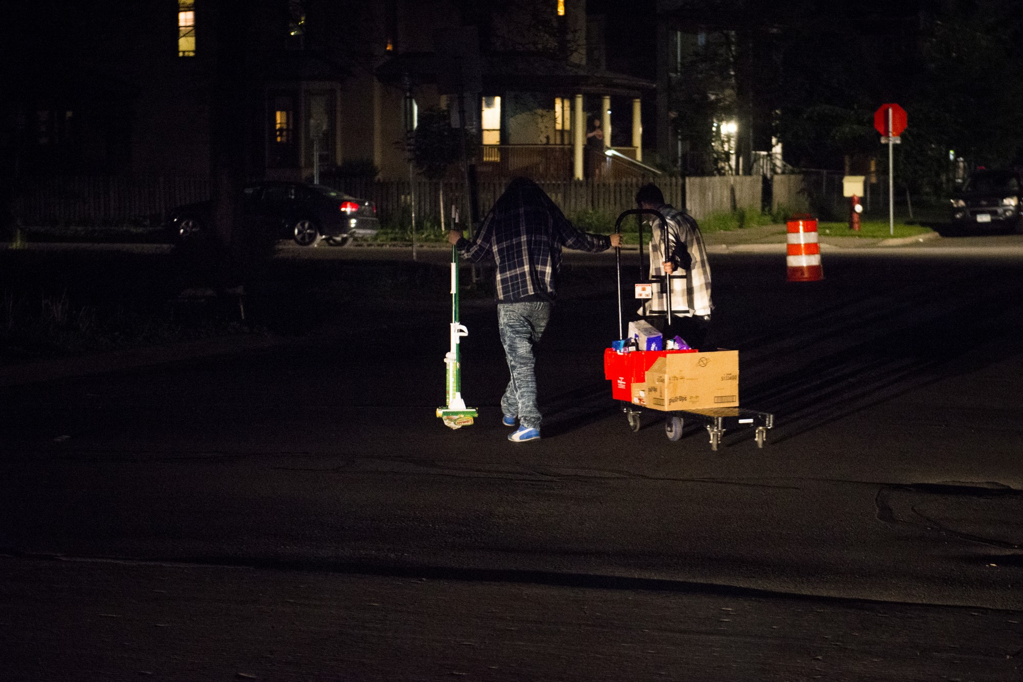 Two men walk away with looted cleaning supplies and assorted items from a Walgreens as part of riots near the 5th precinct in Minneapolis on Friday, May 29. 