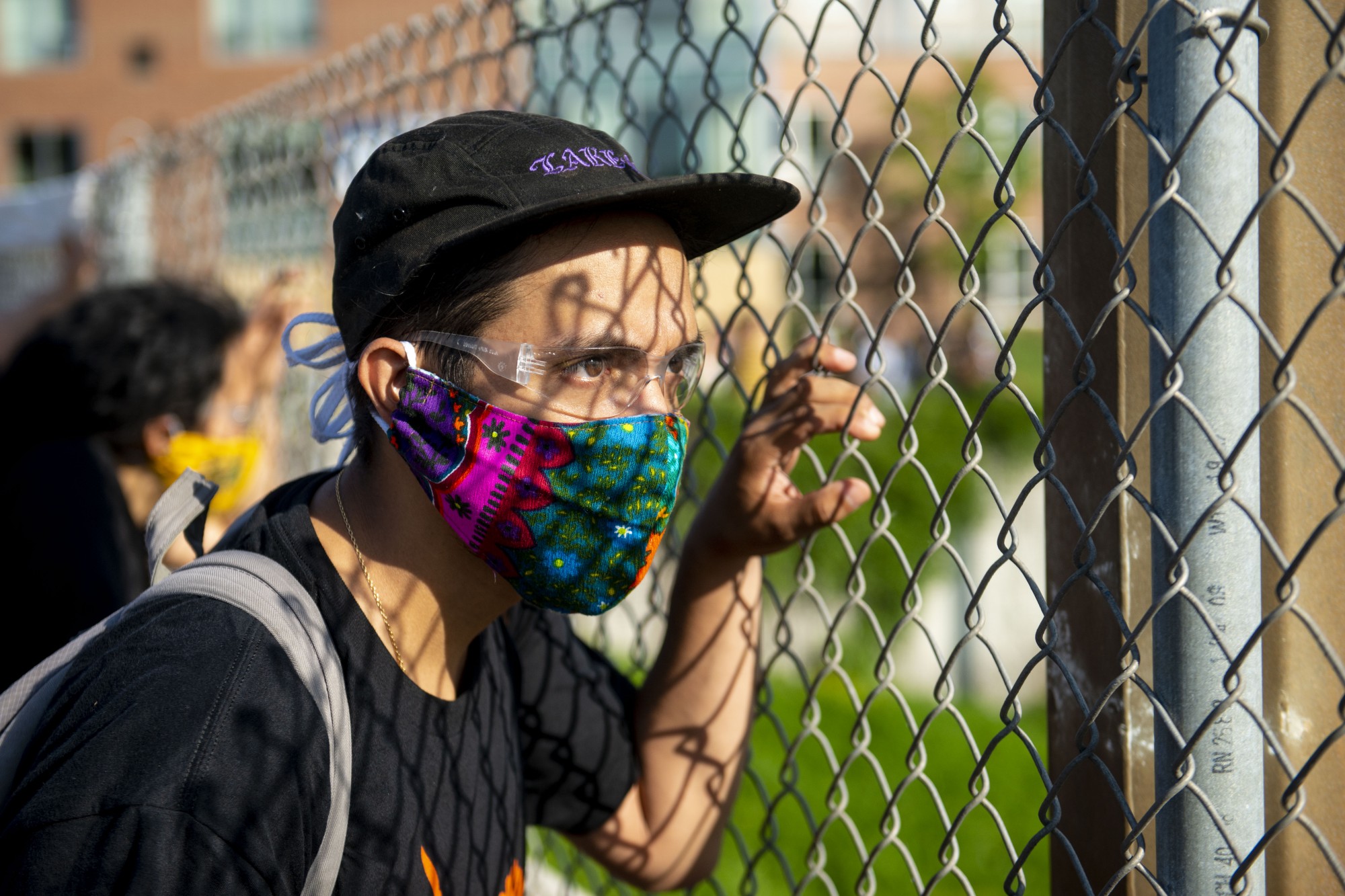 A protestor looks through the fence on the bridge above 35W on Sunday, May 31. 



