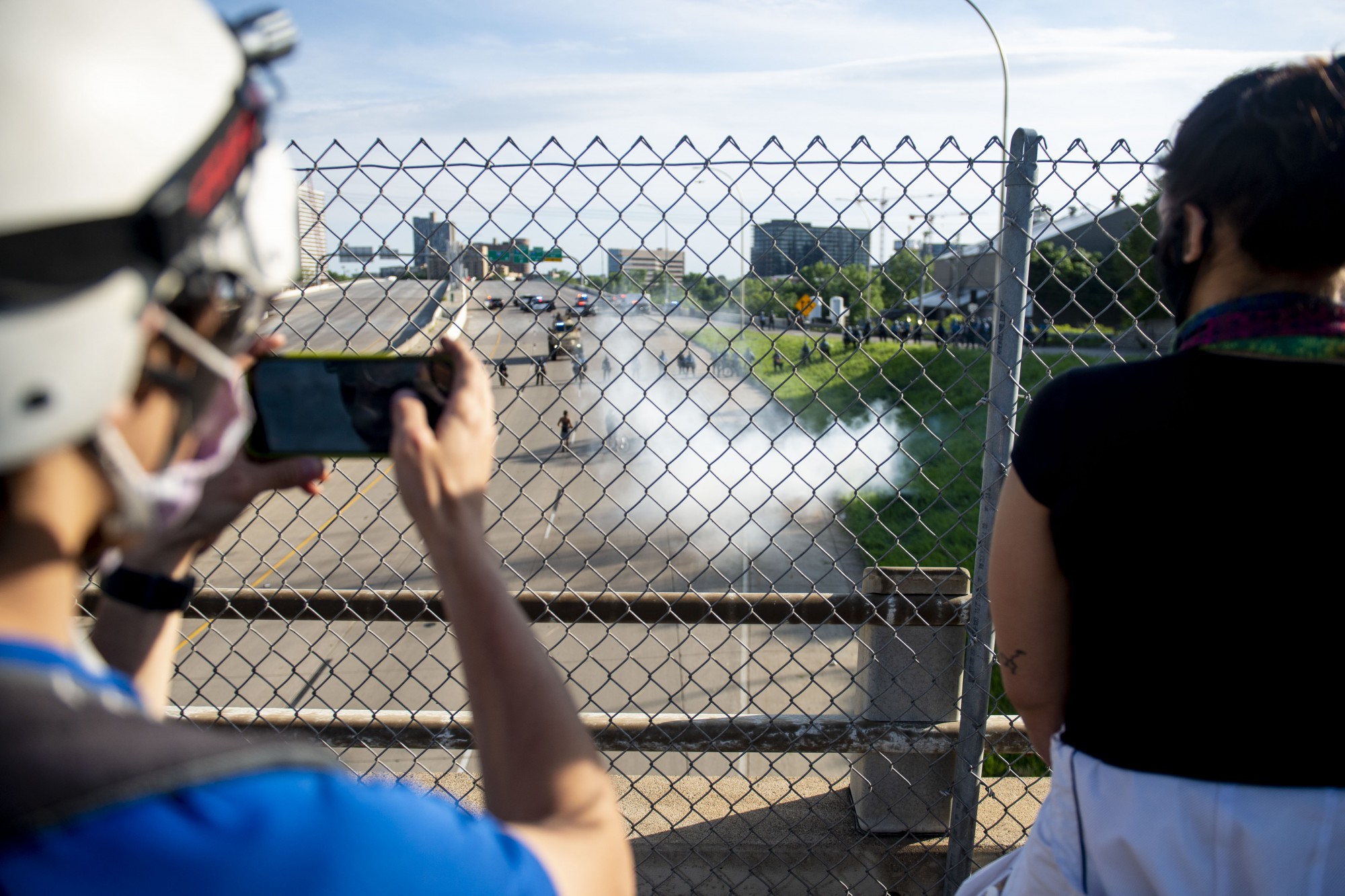 Protesters watch police activity from the bridge above 35W on Sunday, May 31. 