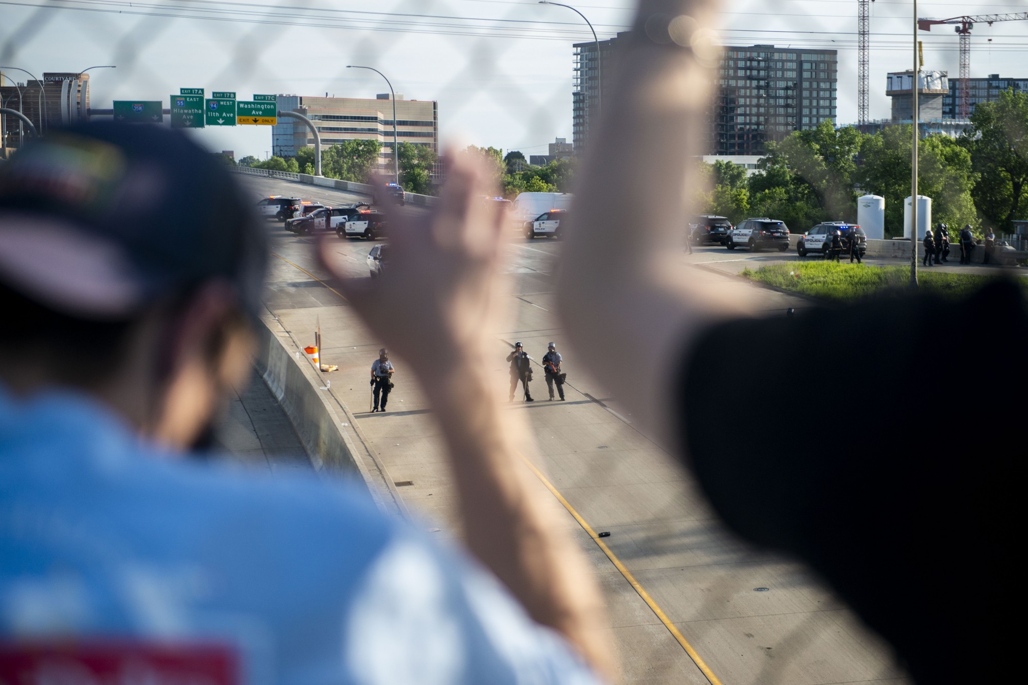 Protesters watch police activity from the bridge above 35W on Sunday, May 31. 