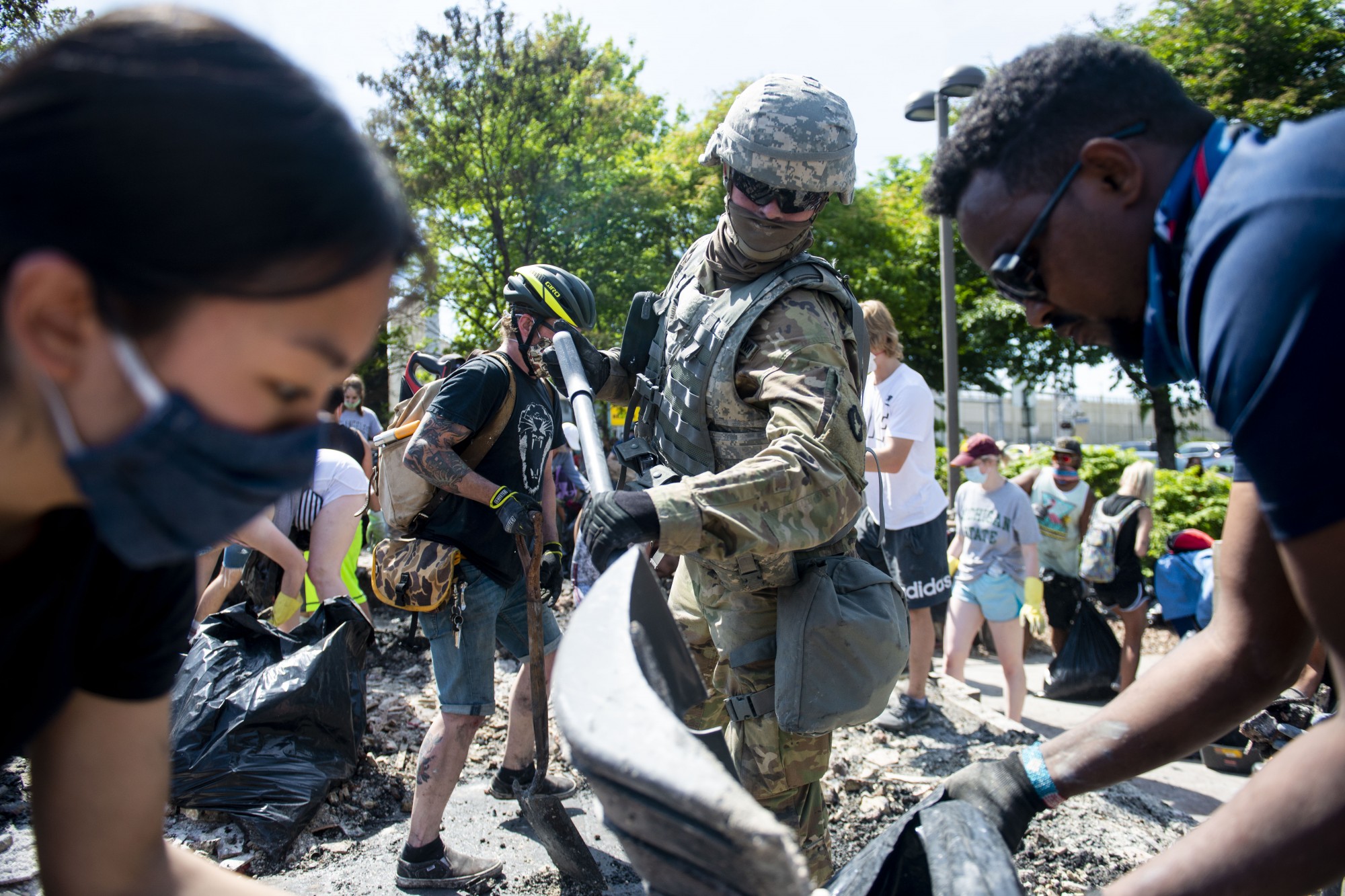 A National Guard soldier helps to clean up debris at an Arbys that was destroyed as part of riots on Lake Street in Minneapolis on Sunday, May 31.