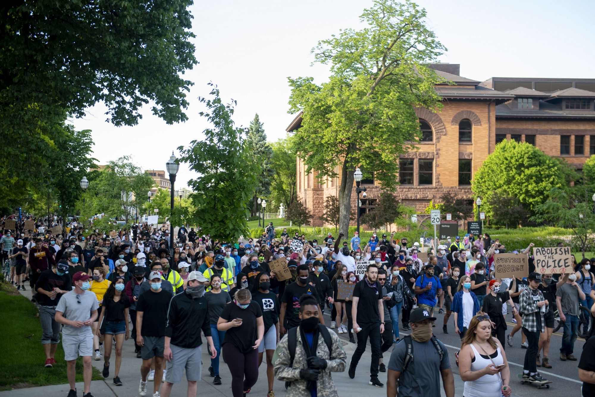 Demonstrators make their way through parts of campus as curfew nears, eventually crossing the Stone Arch Bridge and into downtown on Sunday, May 31. 