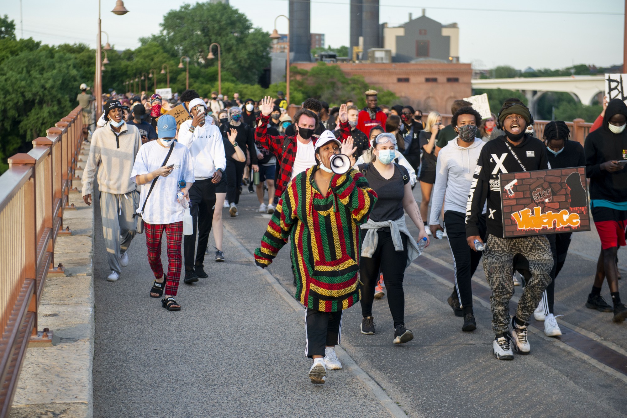Demonstrators make their way through parts of campus as curfew nears, eventually crossing the Stone Arch Bridge and into downtown on Sunday, May 31. 