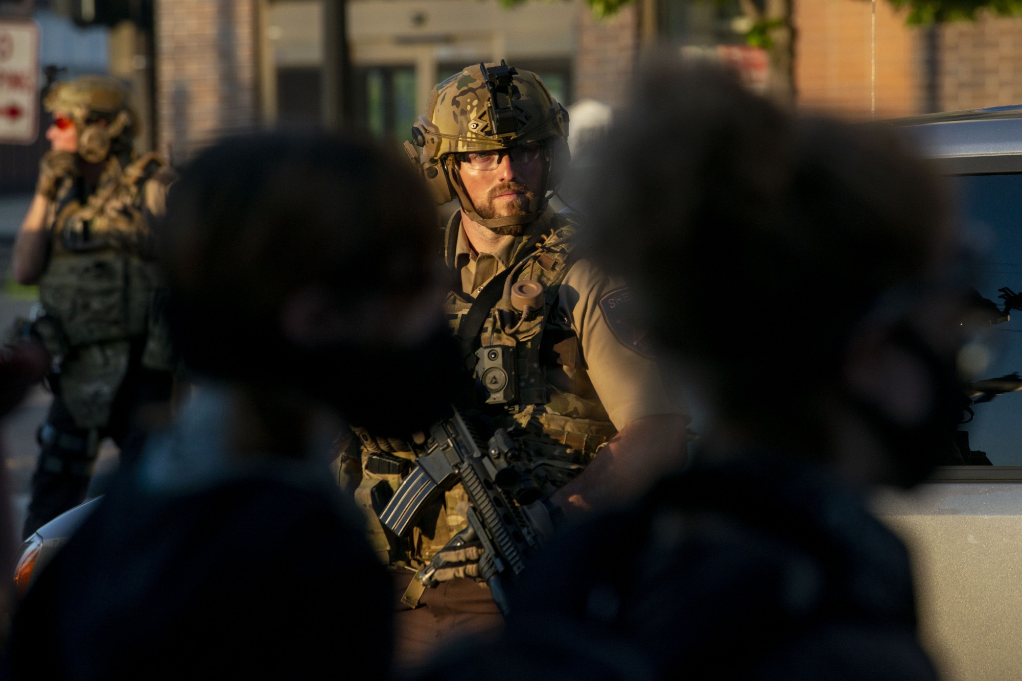 SWAT officers patrol the intersection of Southeast 4th Street and 15th Avenue Southeast just after 8 p.m. on Monday, June 1. Several people were arrested during a mostly student-led demonstration halting traffic at the intersection. 